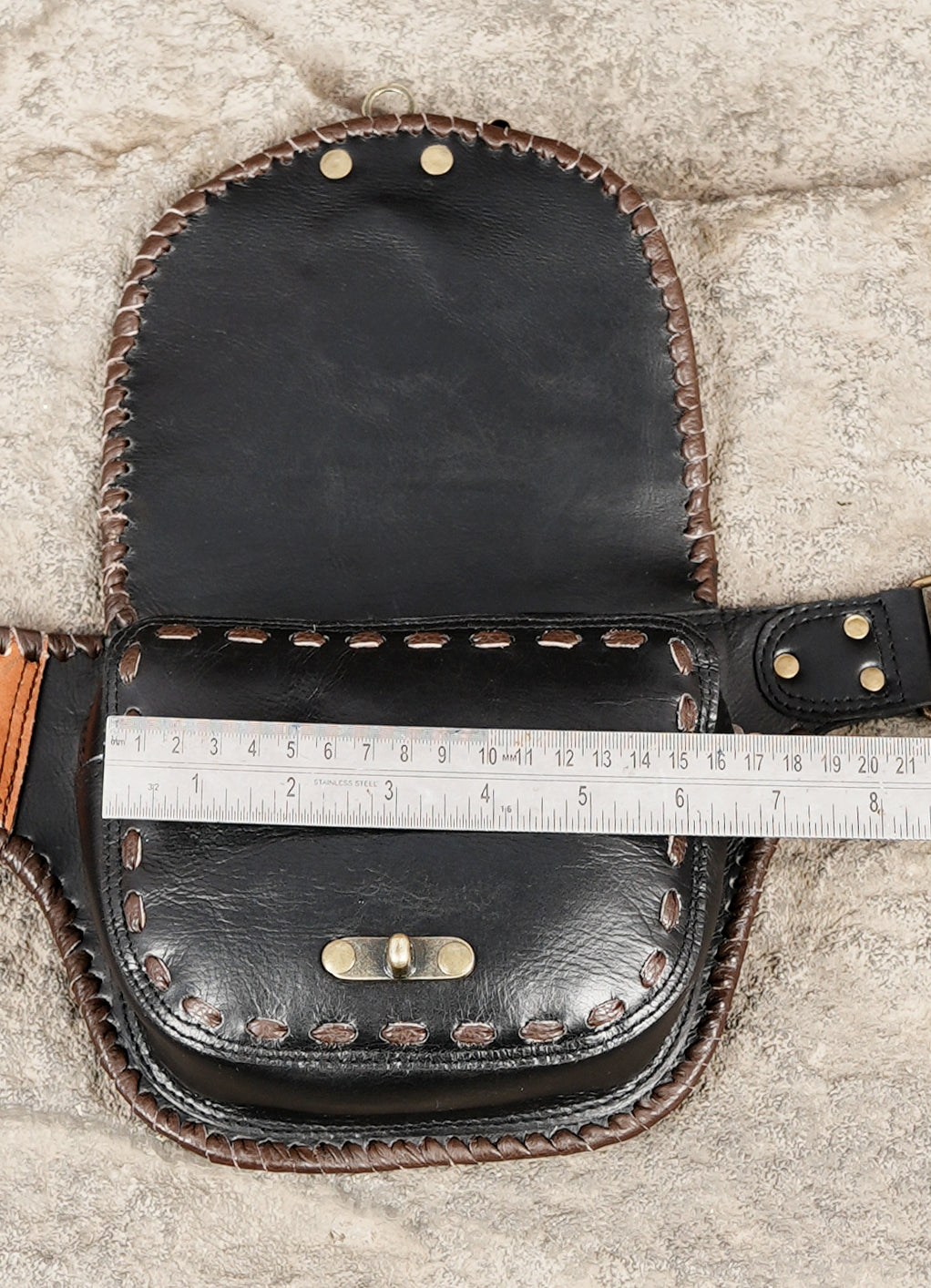 Black leather hip bag with tan leather stone accents