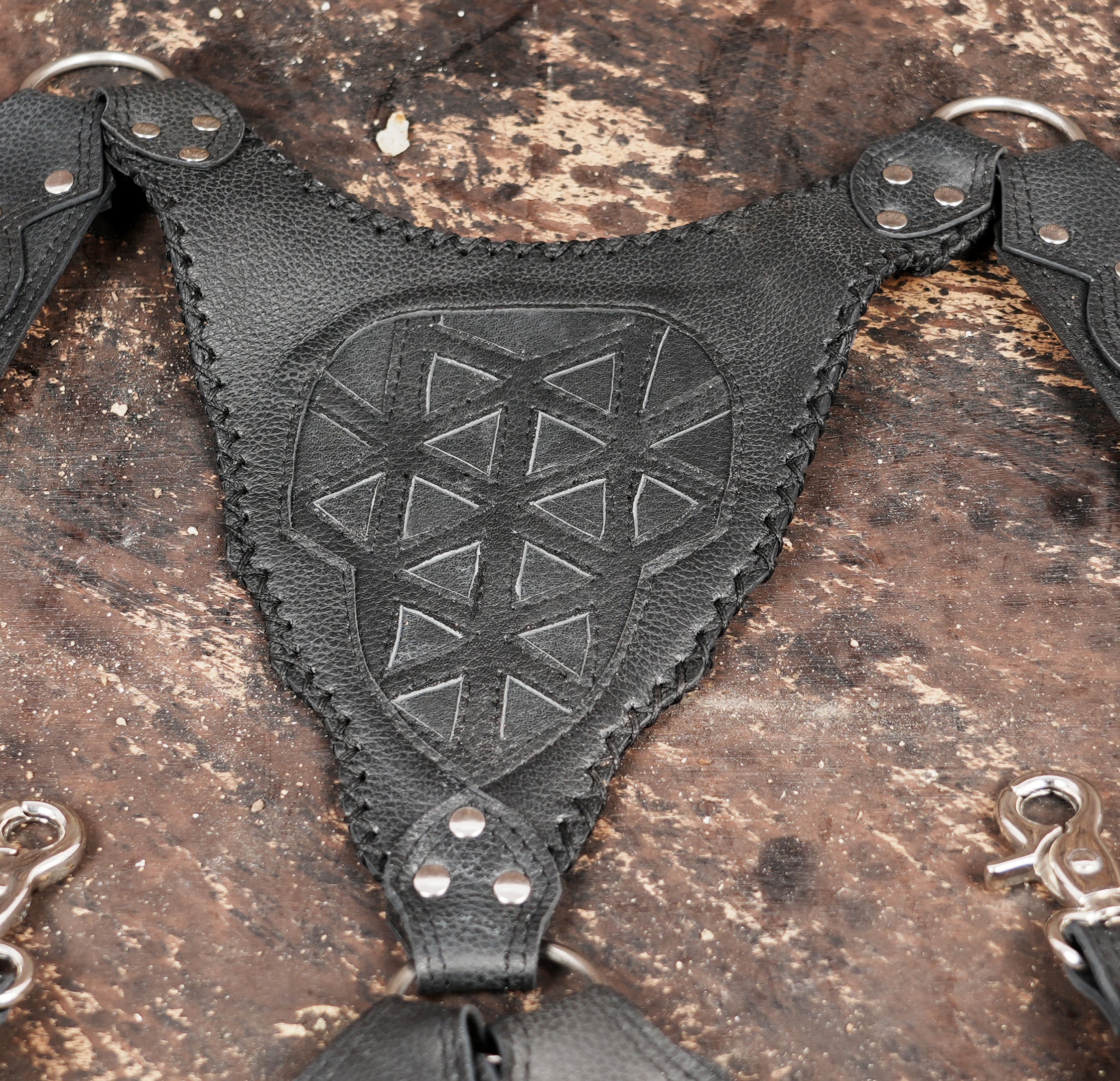 Black leather shoulder holster with dual pouches and tribal pattern