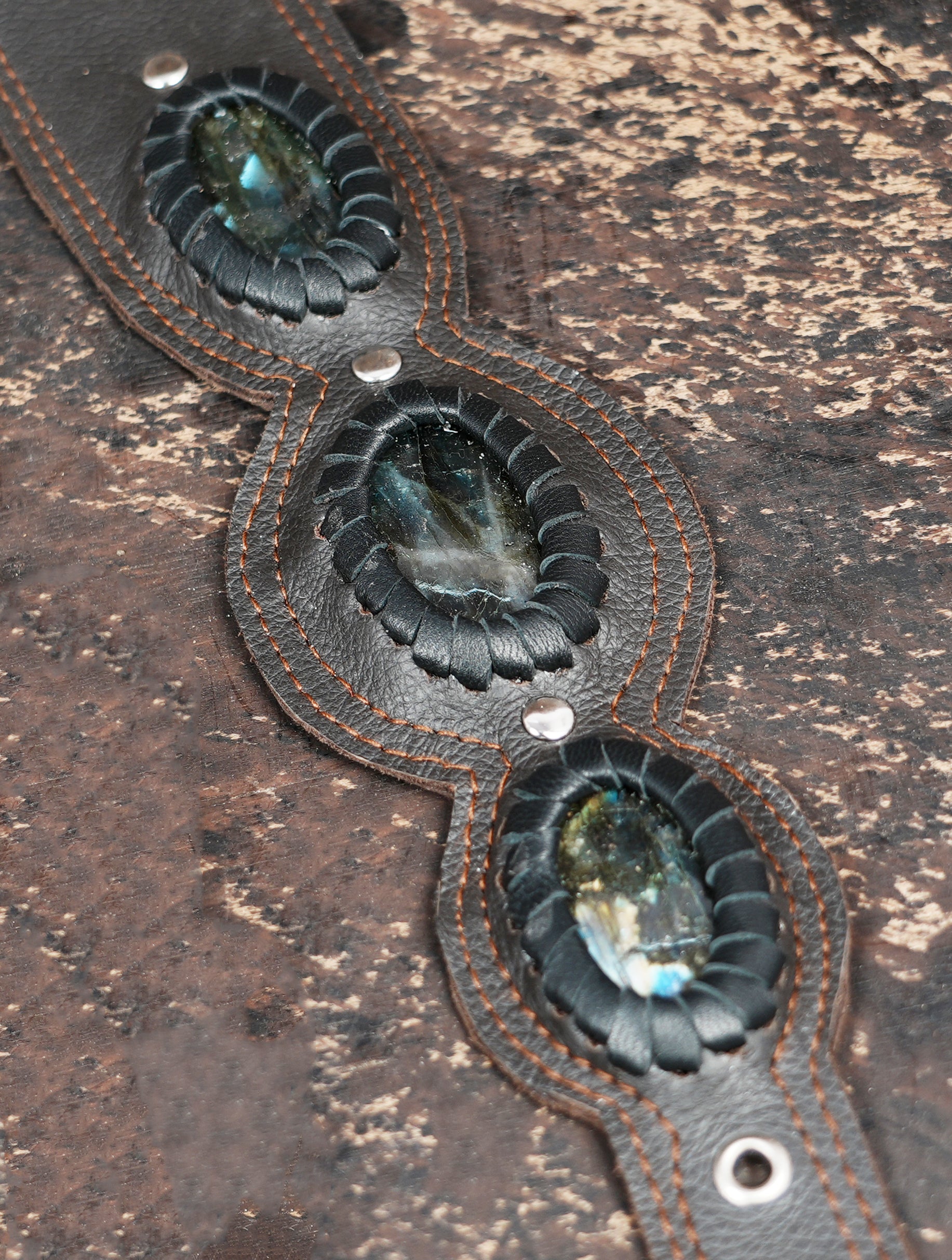 Bohemian style leather holster with geometric stitching and Om symbol