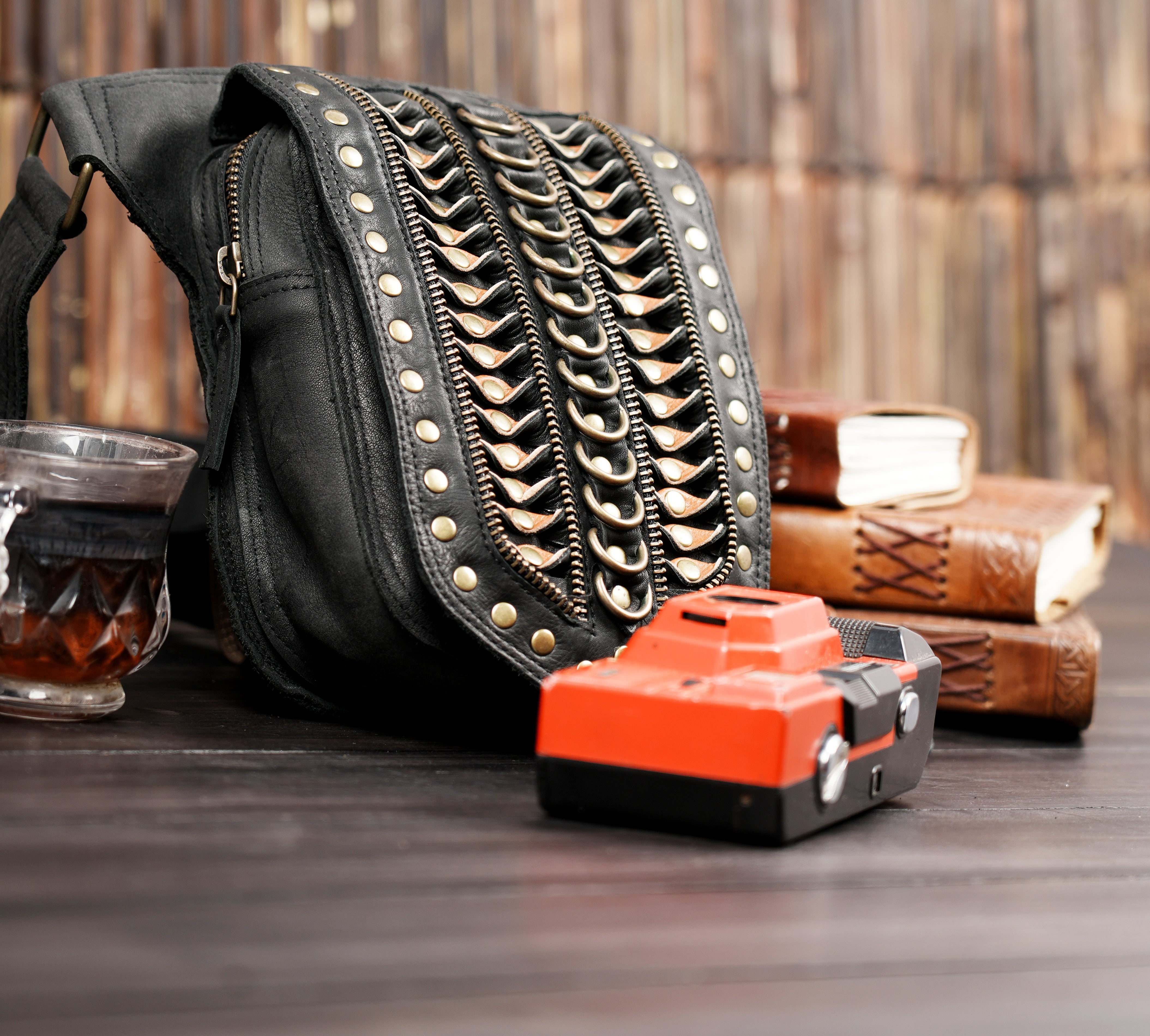 Adjustable leather waist belt with metal rivets and chain design