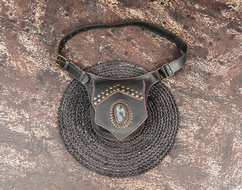 Handcrafted leather waist belt with braided detailing and stone centerpiece