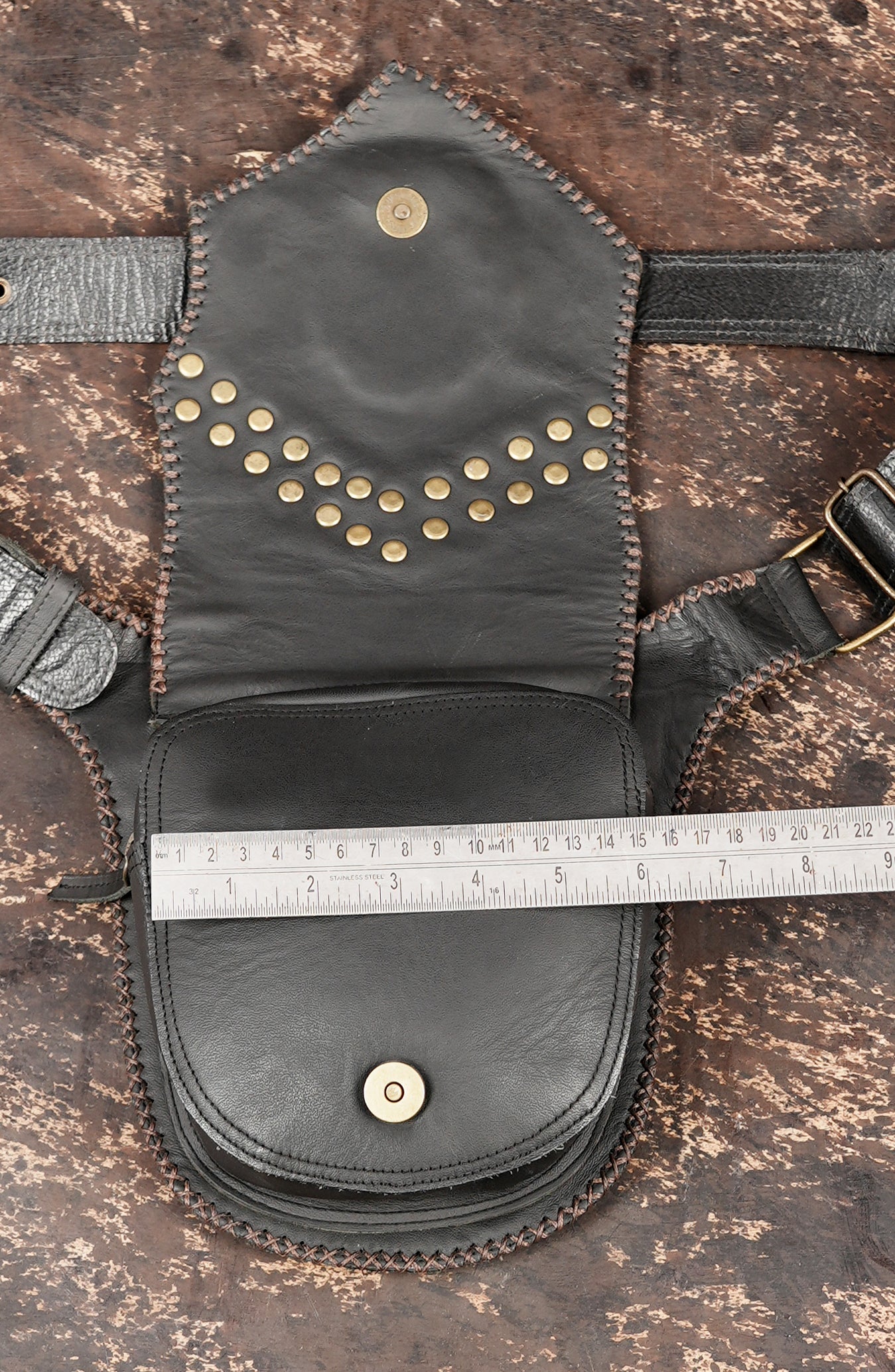 Hand stitched leather belt with woven texture and stone ornament