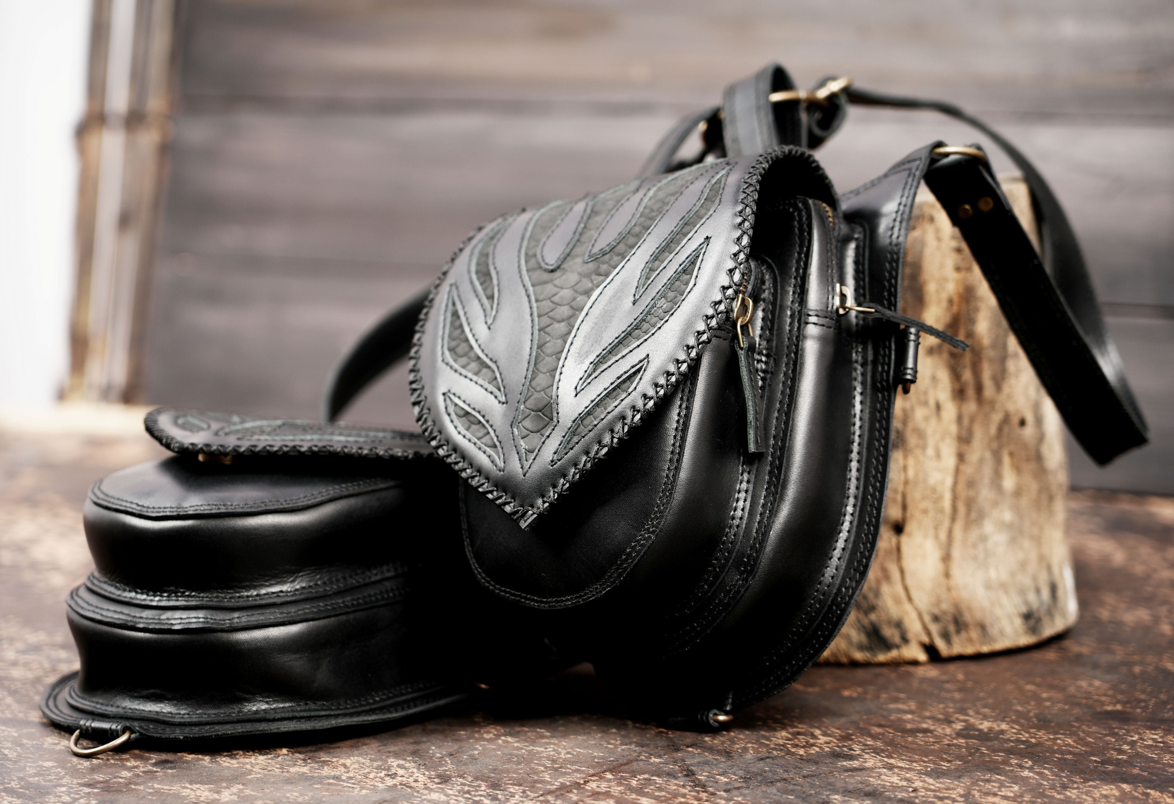 Adjustable black leather utility pouch with strap system