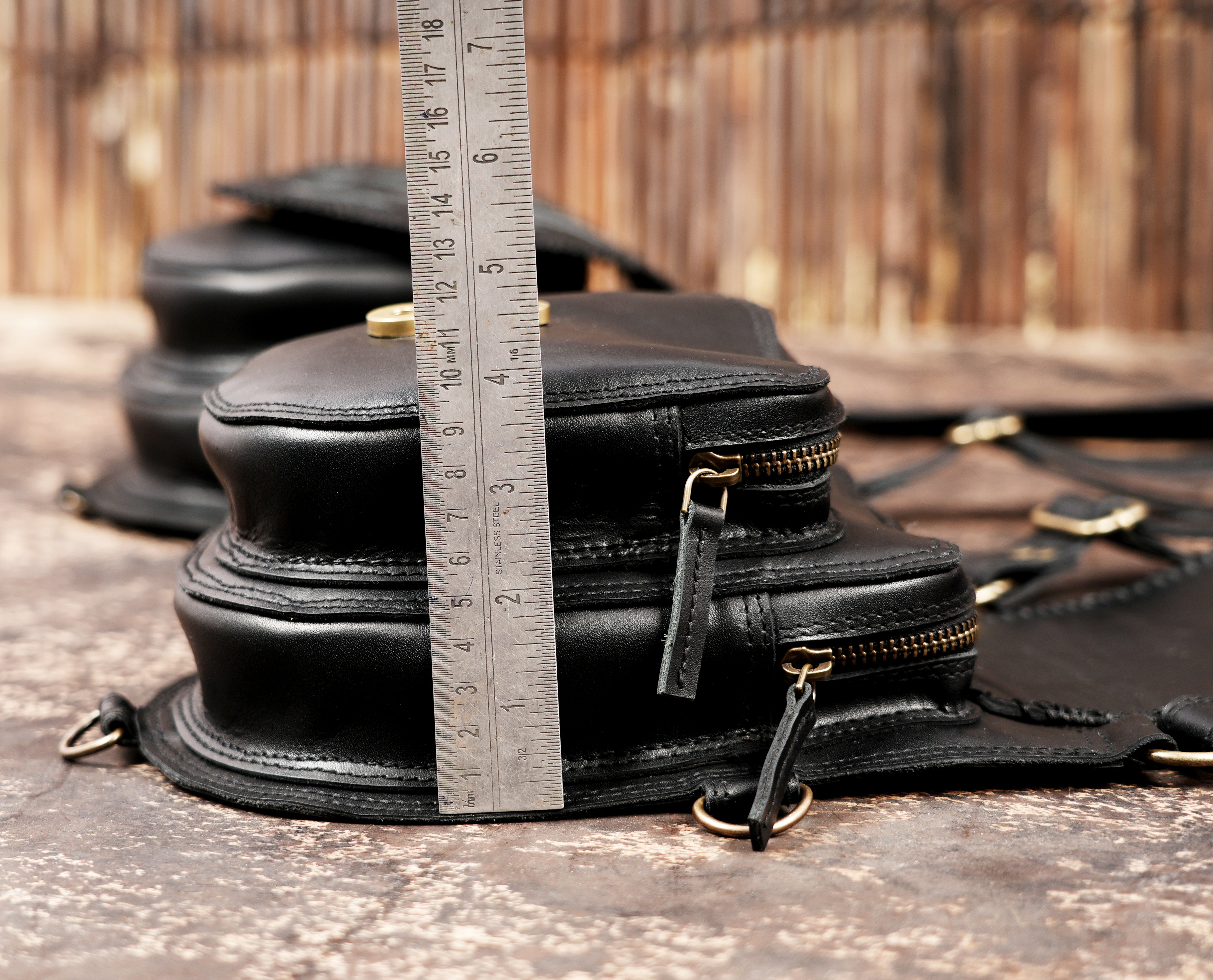 Black leather leg holster with adjustable belt and shoulder straps