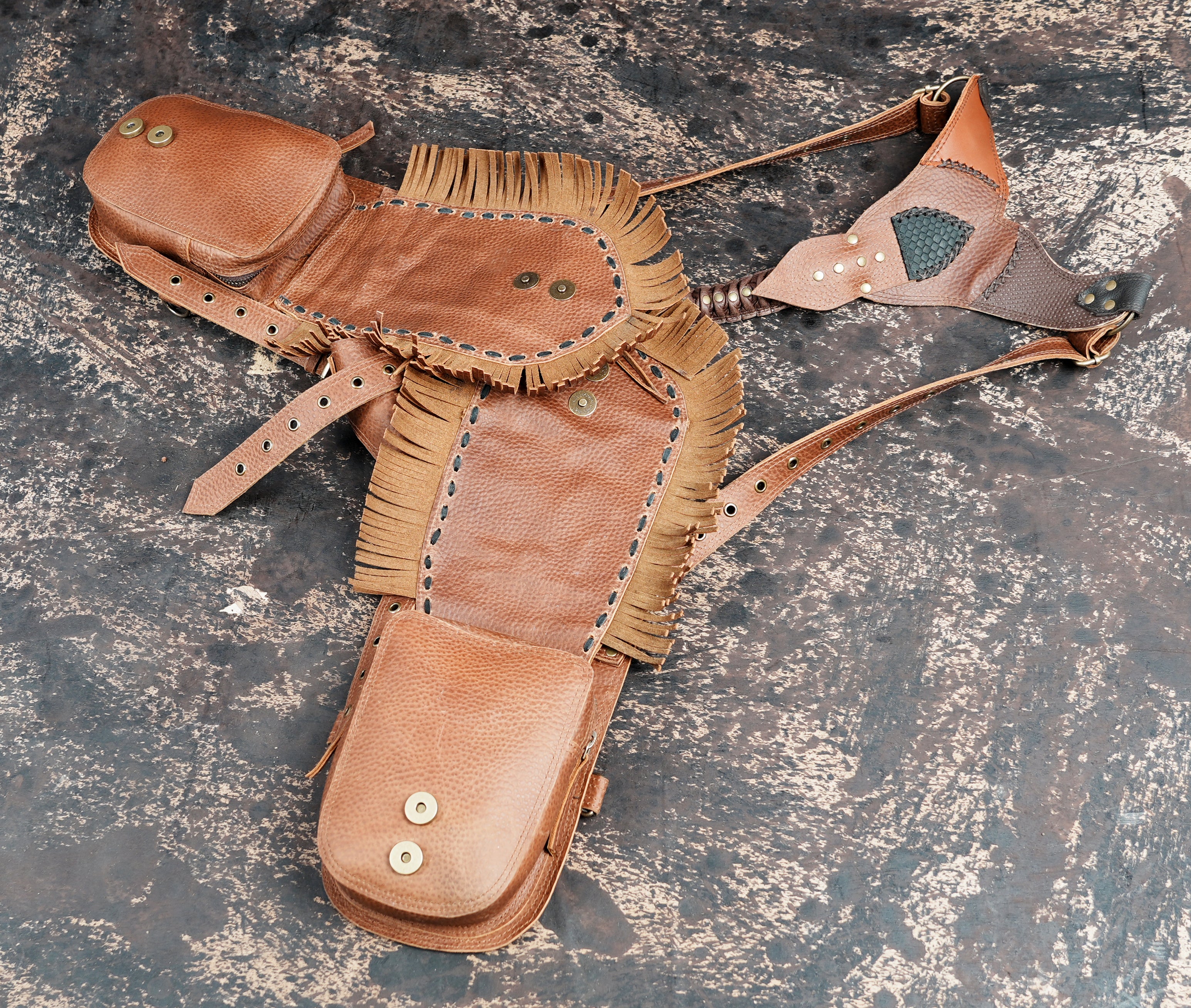 Leather holster bag with fringe accents and buckle straps