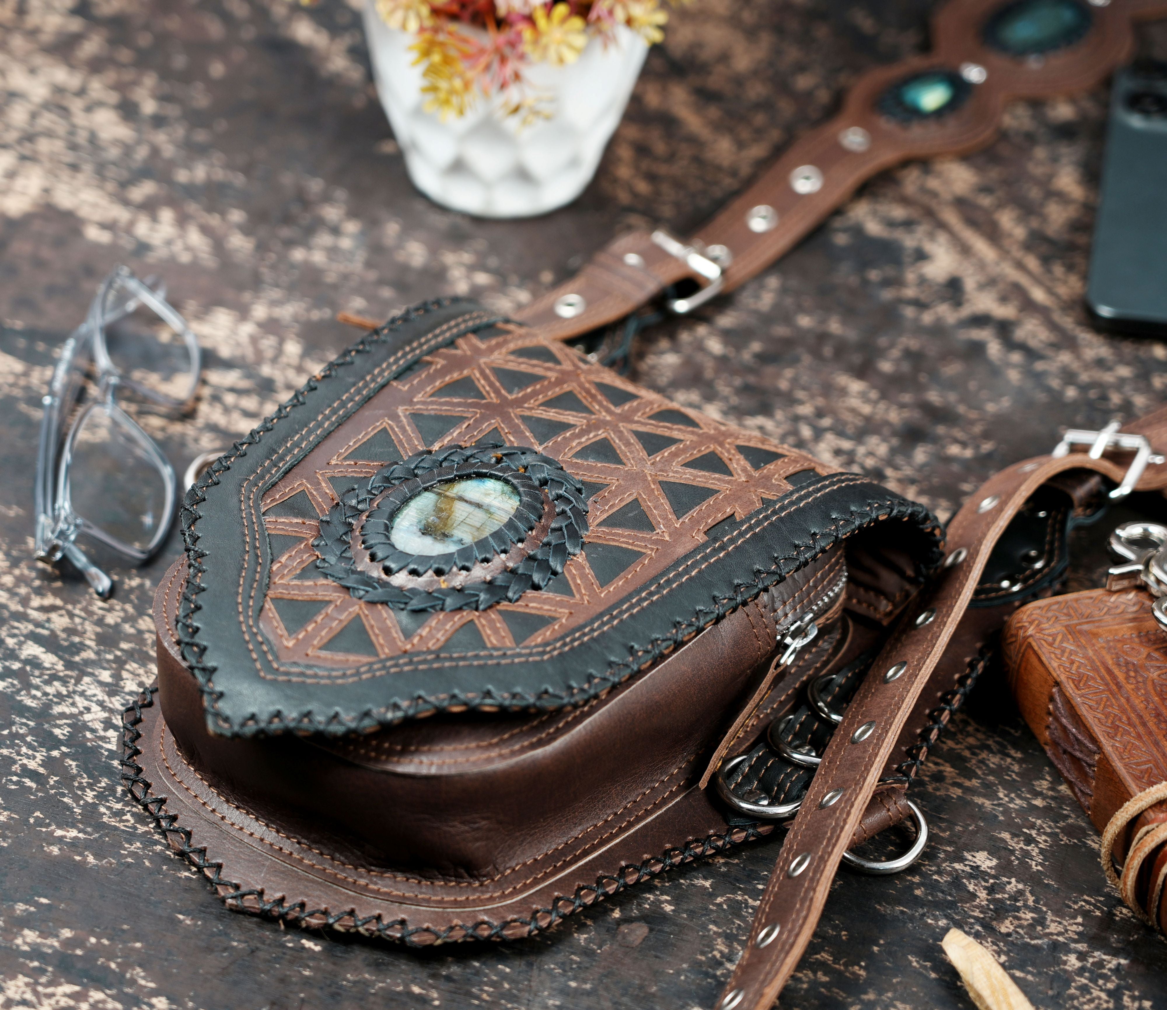 Handcrafted leather holster with engraved design and stone inlay