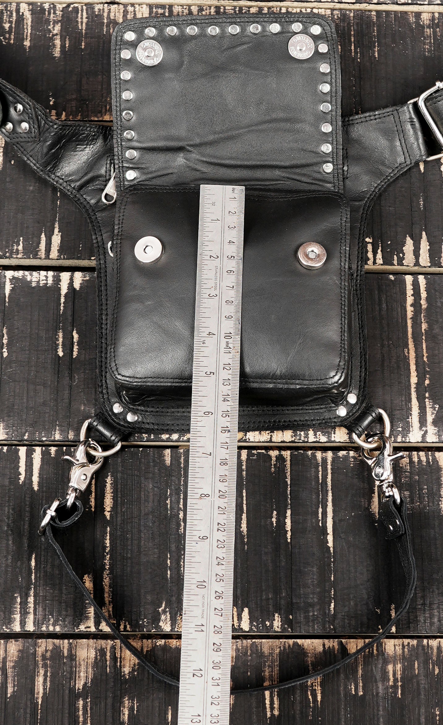 Adjustable black leather thigh harness with detachable leg strap