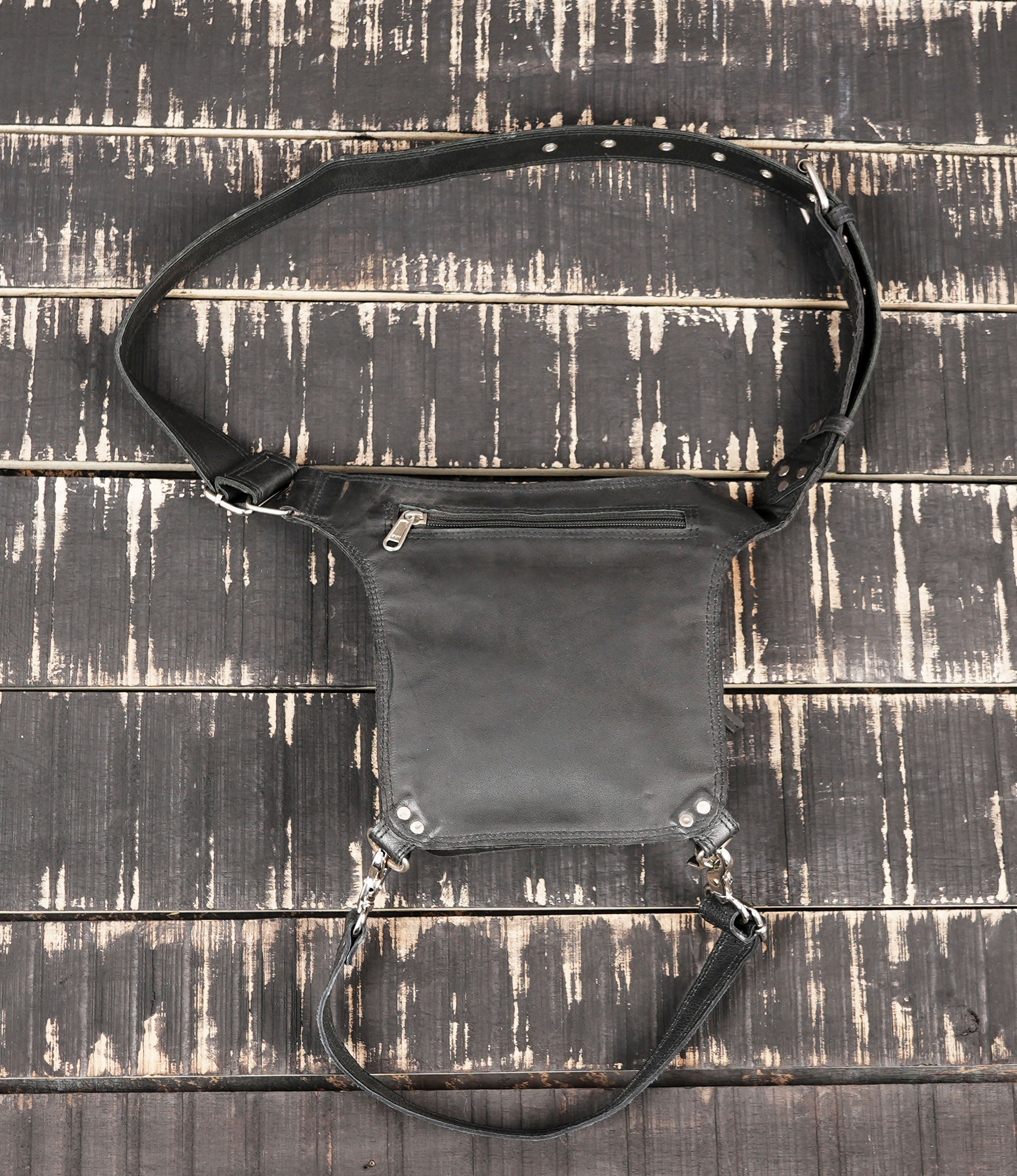 Minimalist black leather thigh belt bag with metal hardware