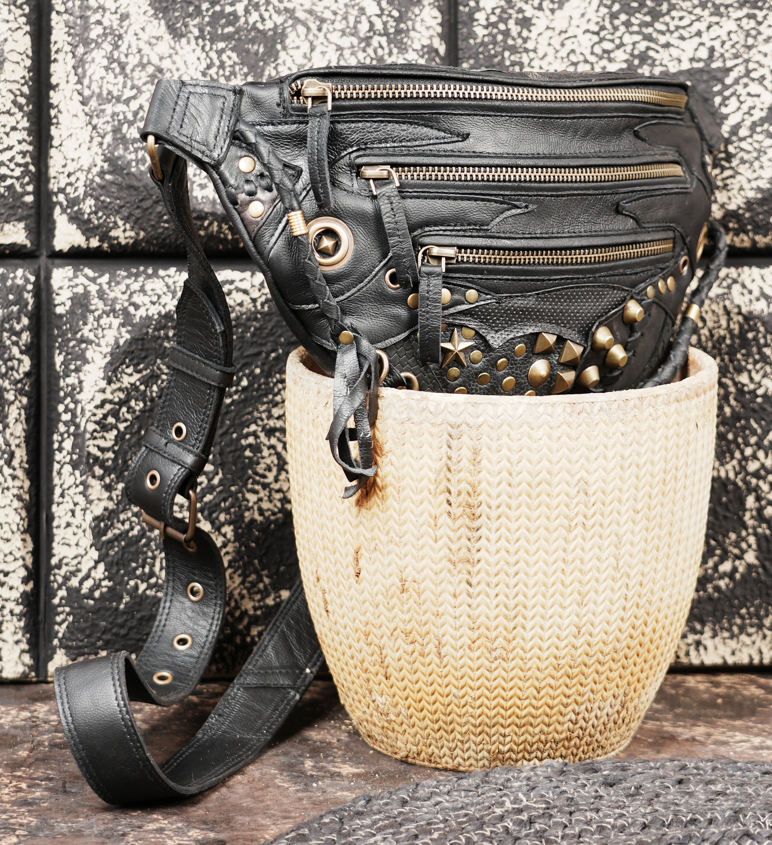 Durable black leather shoulder belt with utility pocket design