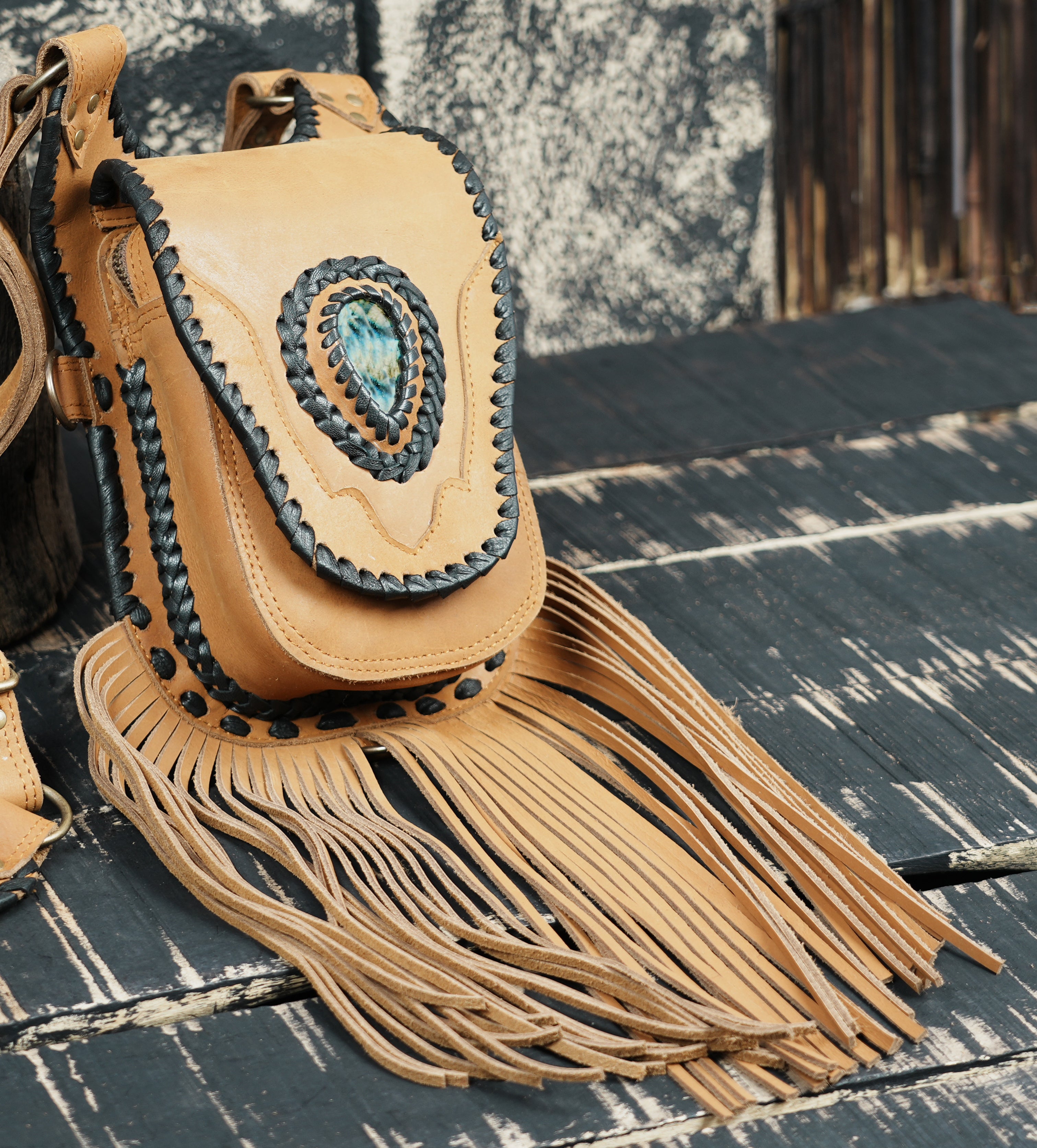 Rustic tan leather holster bag with fringe and snap closure