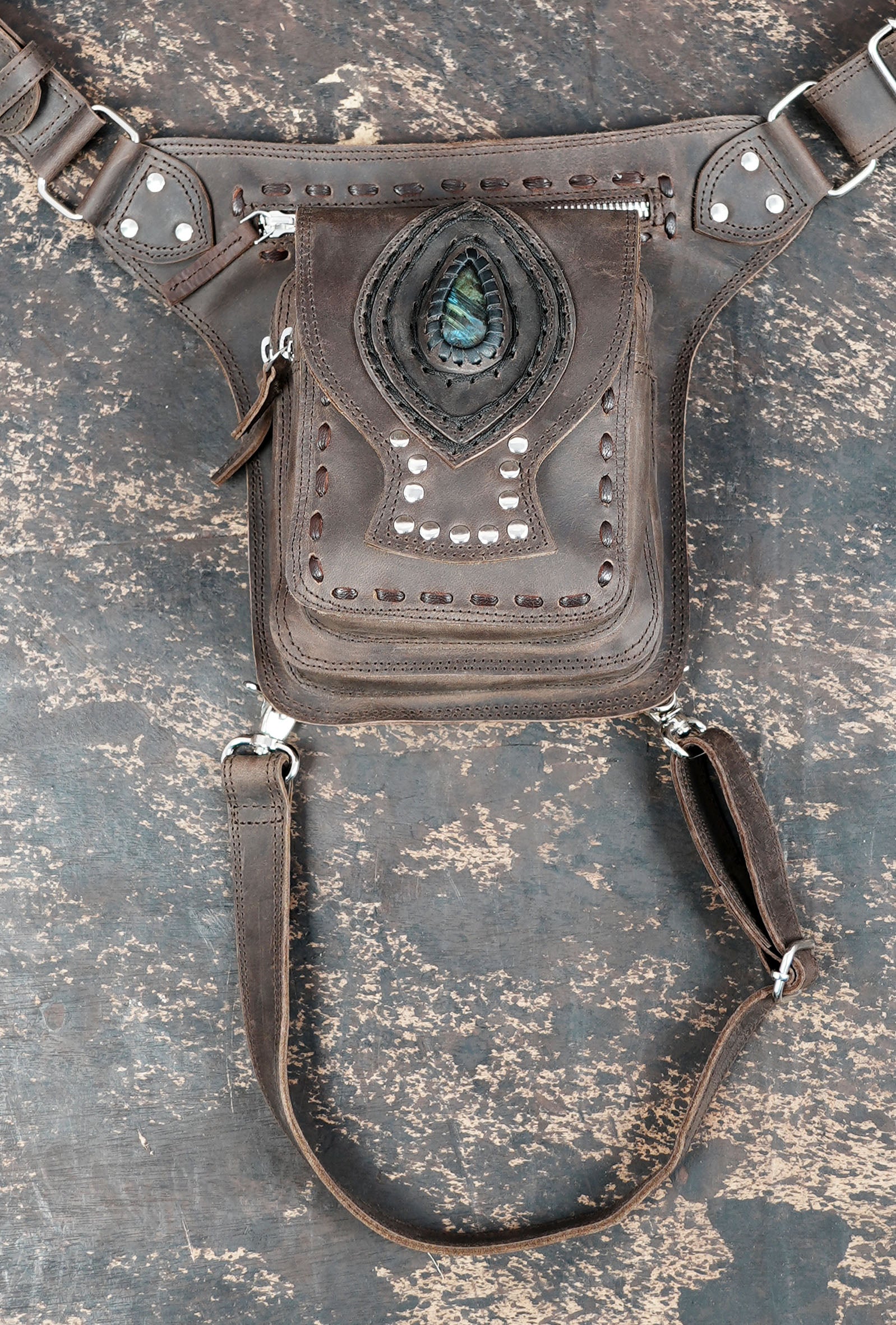 Brown leather thigh belt bag with zipper pocket and stud details