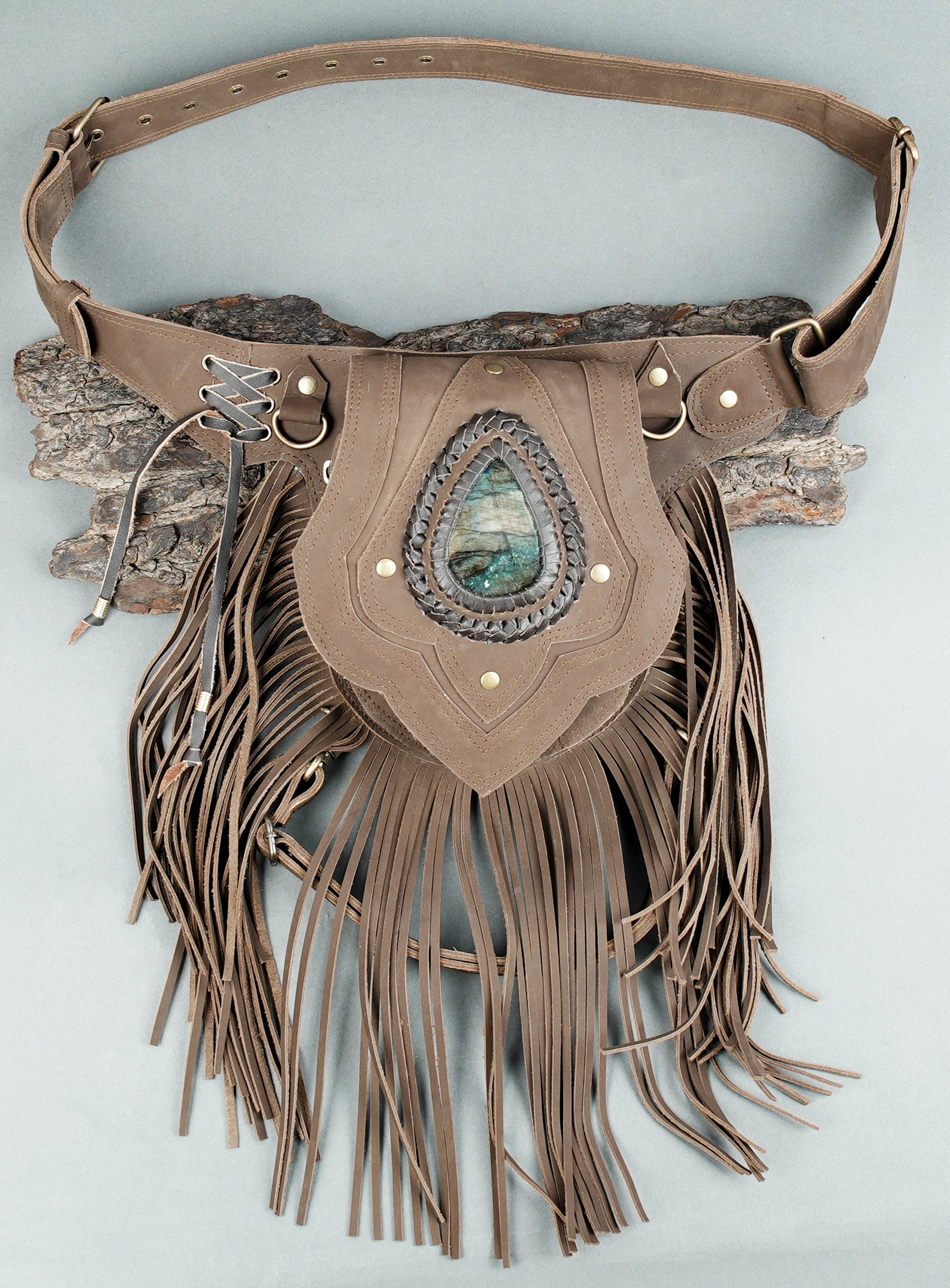 black leather waist piece with artisan fringe and stone accent