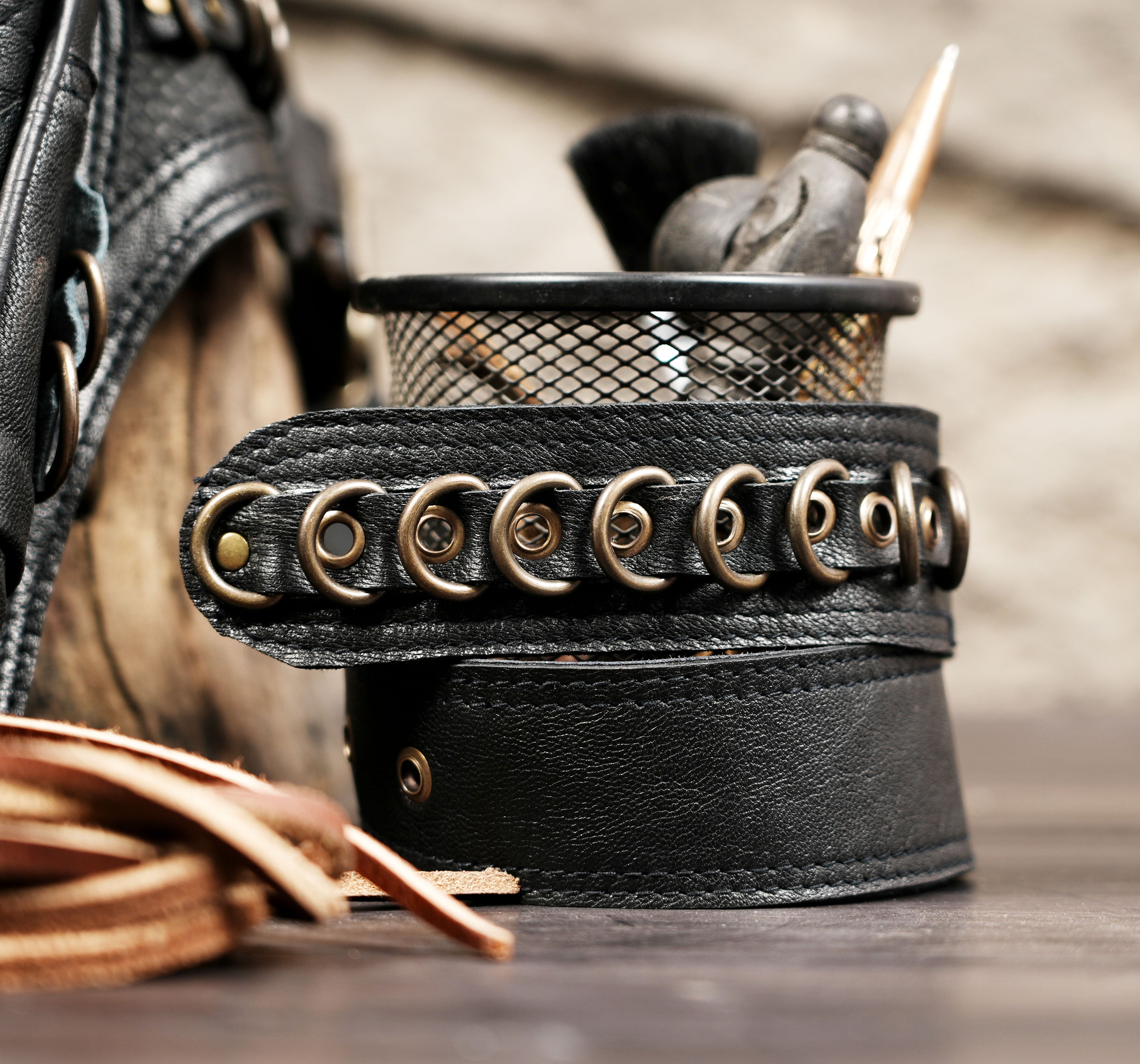 Black leather utility waist belt with front pouch and brass accents