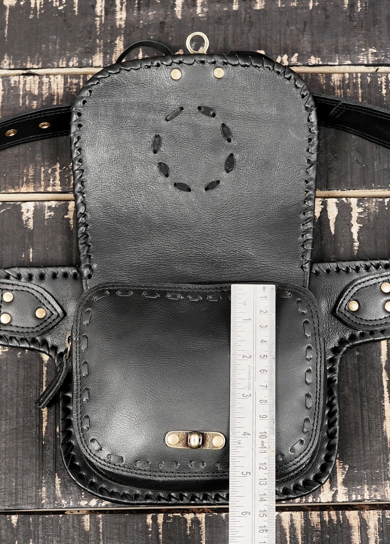 Black leather waist belt bag with handcrafted borders and secure clasp