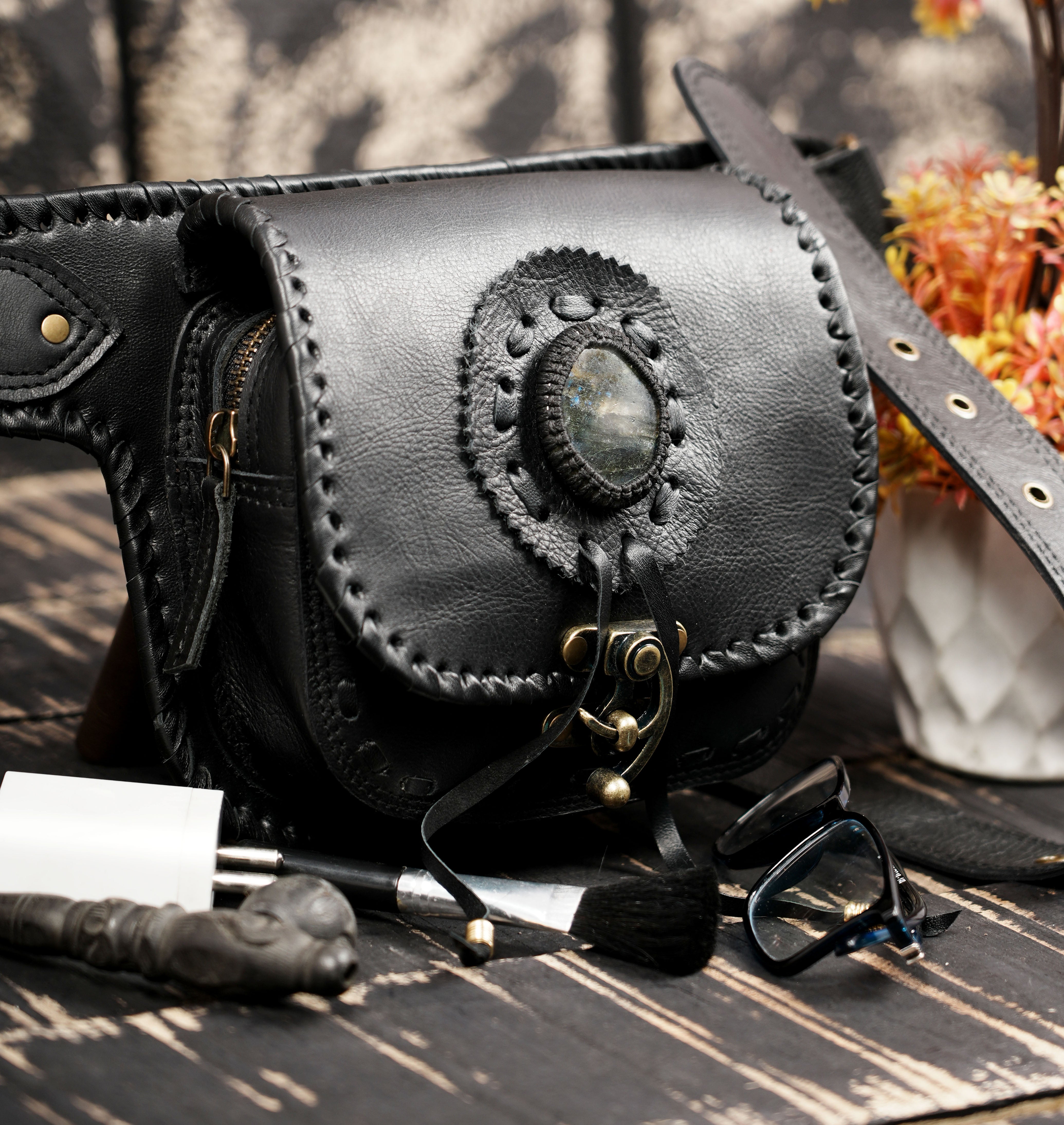 Black leather belt pouch with handcrafted stitching and metal hardware