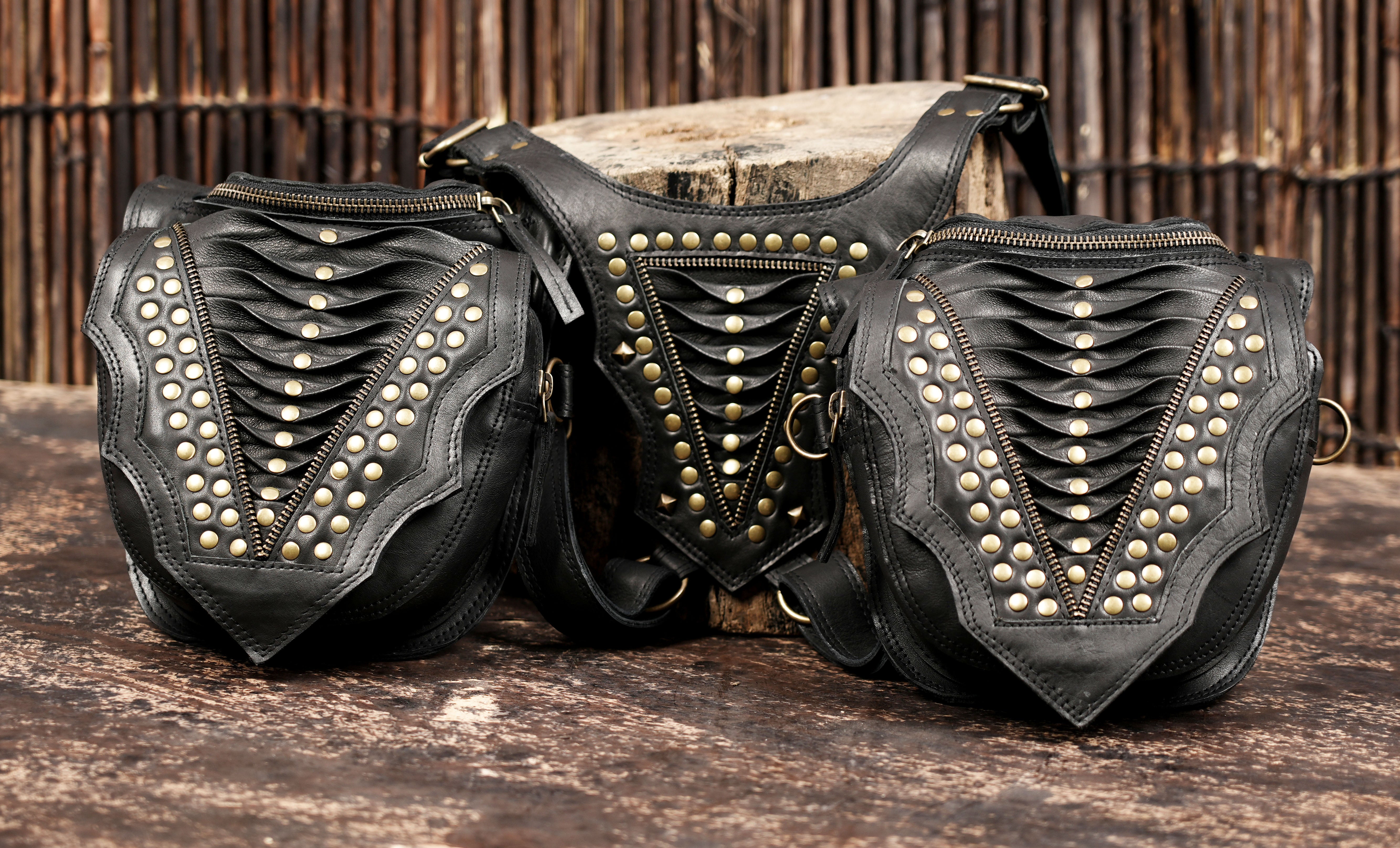 Biker style leather holster bag with rugged straps and decorative studs
