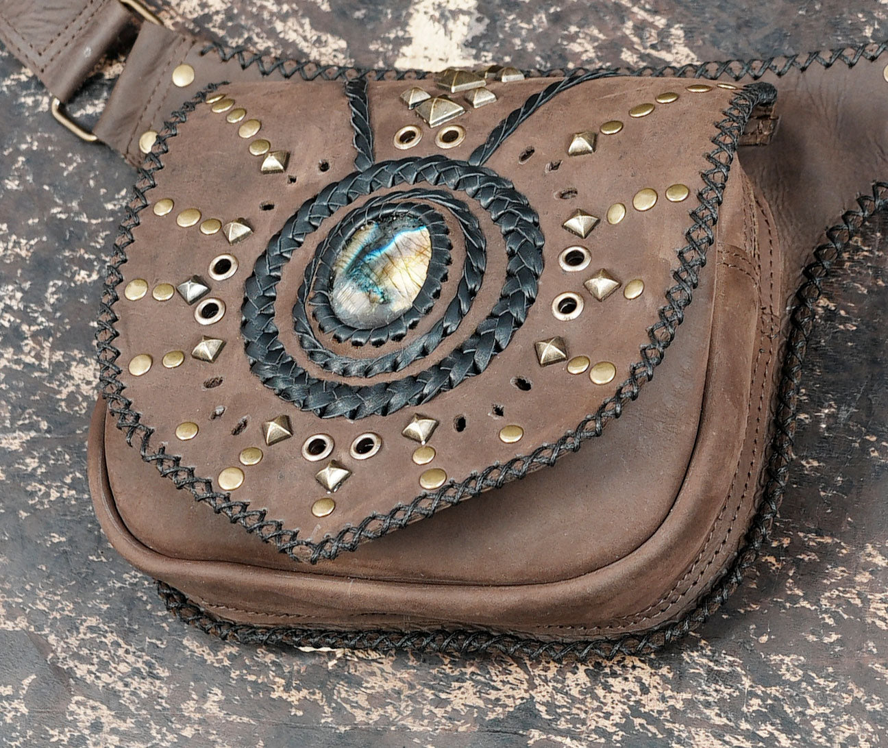 Brown leather waist pouch with stud work and braided design
