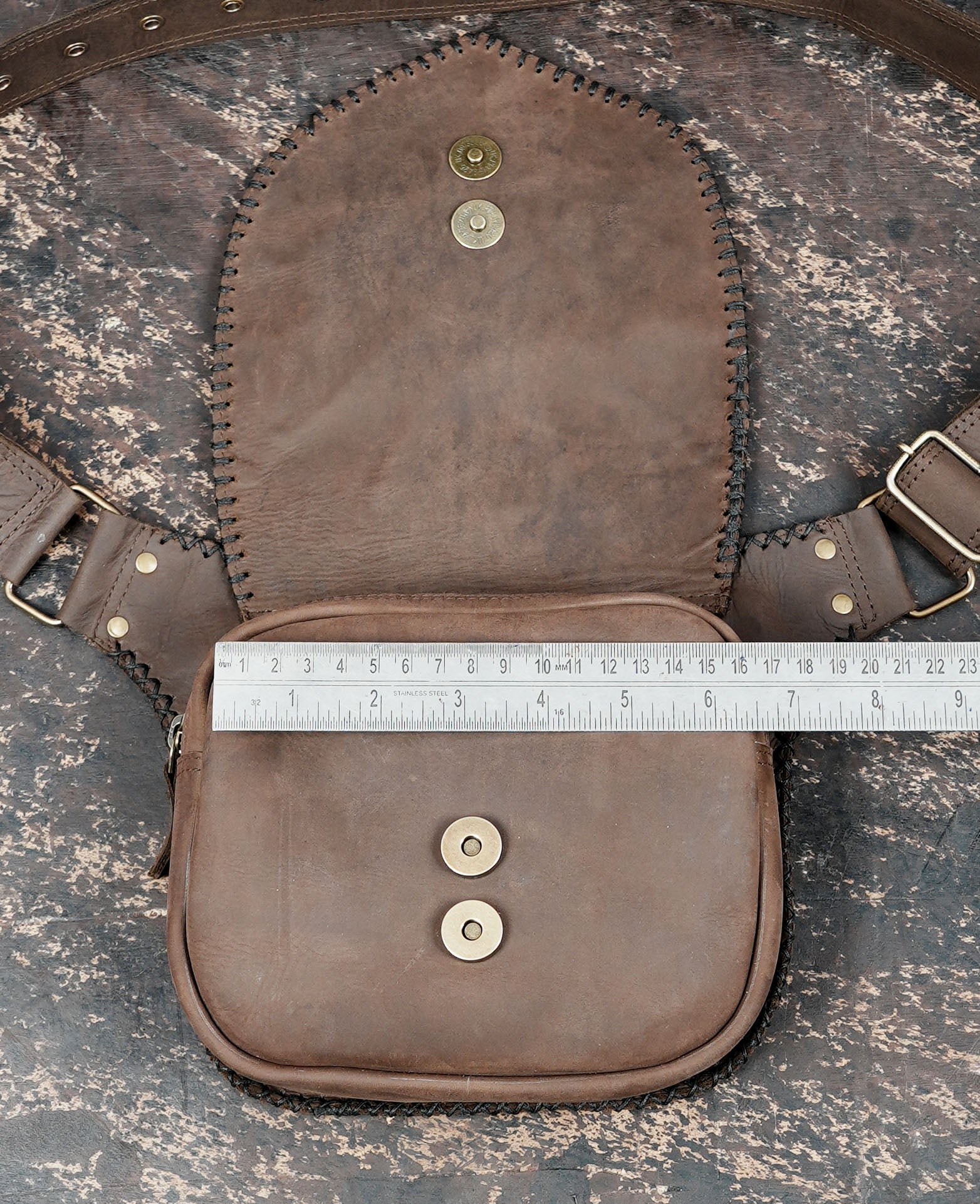Leather waist bag with front flap pocket and zipper closure