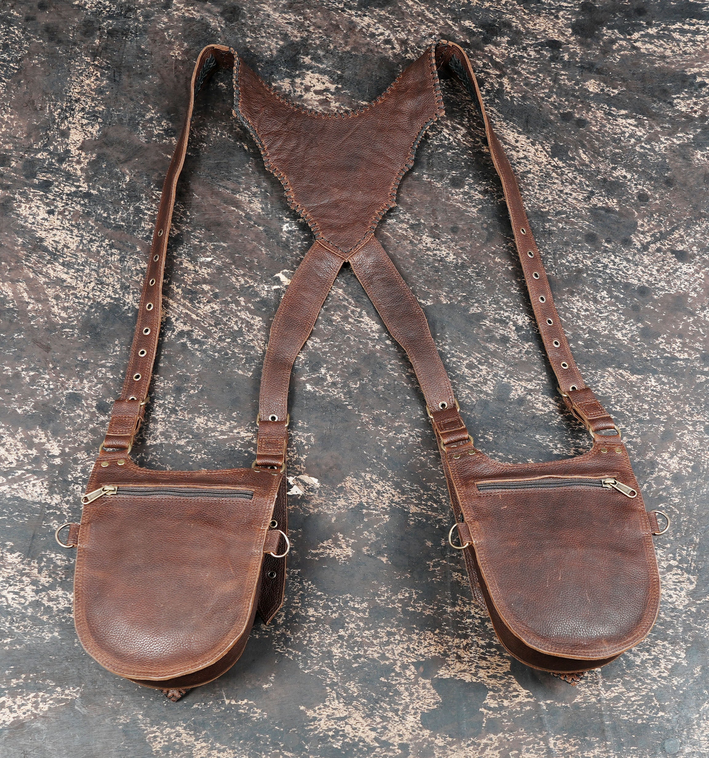 Utility leather holster harness with strong stitching and metal fittings