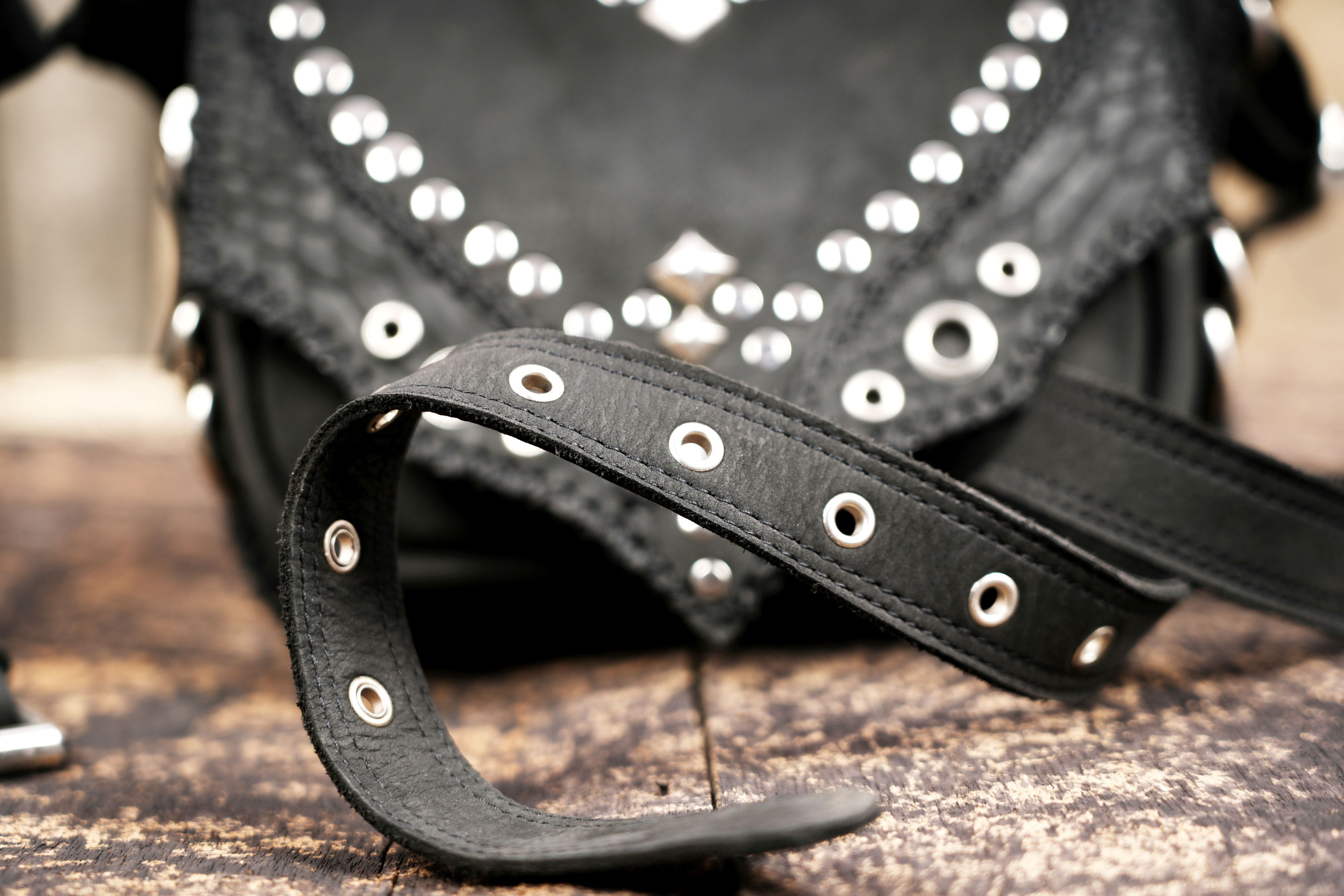 "Black leather utility belt pouch with silver rivet detailing"
