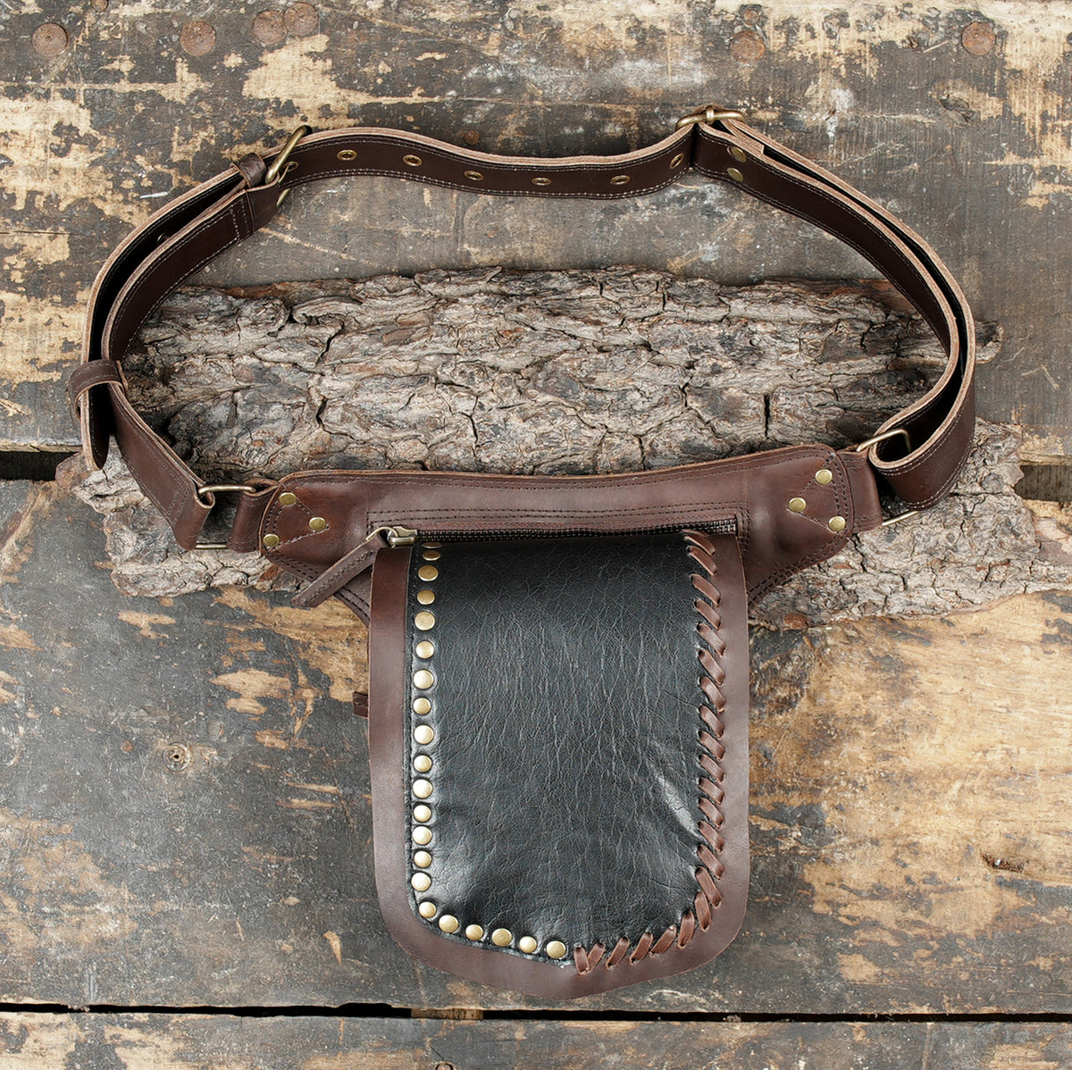 Handmade leather hip pouch attached to an adjustable brown belt   