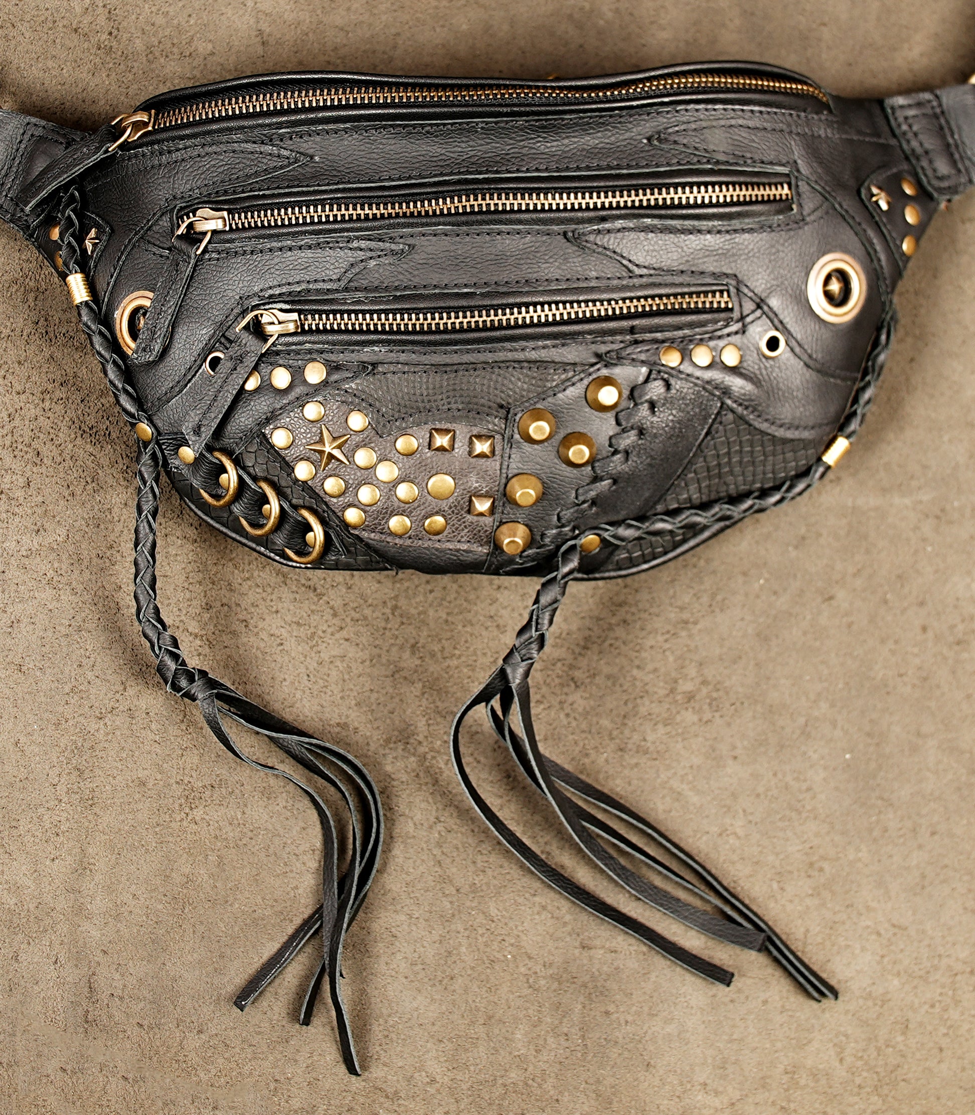Biker style black leather utility thigh holster bag with brass details.