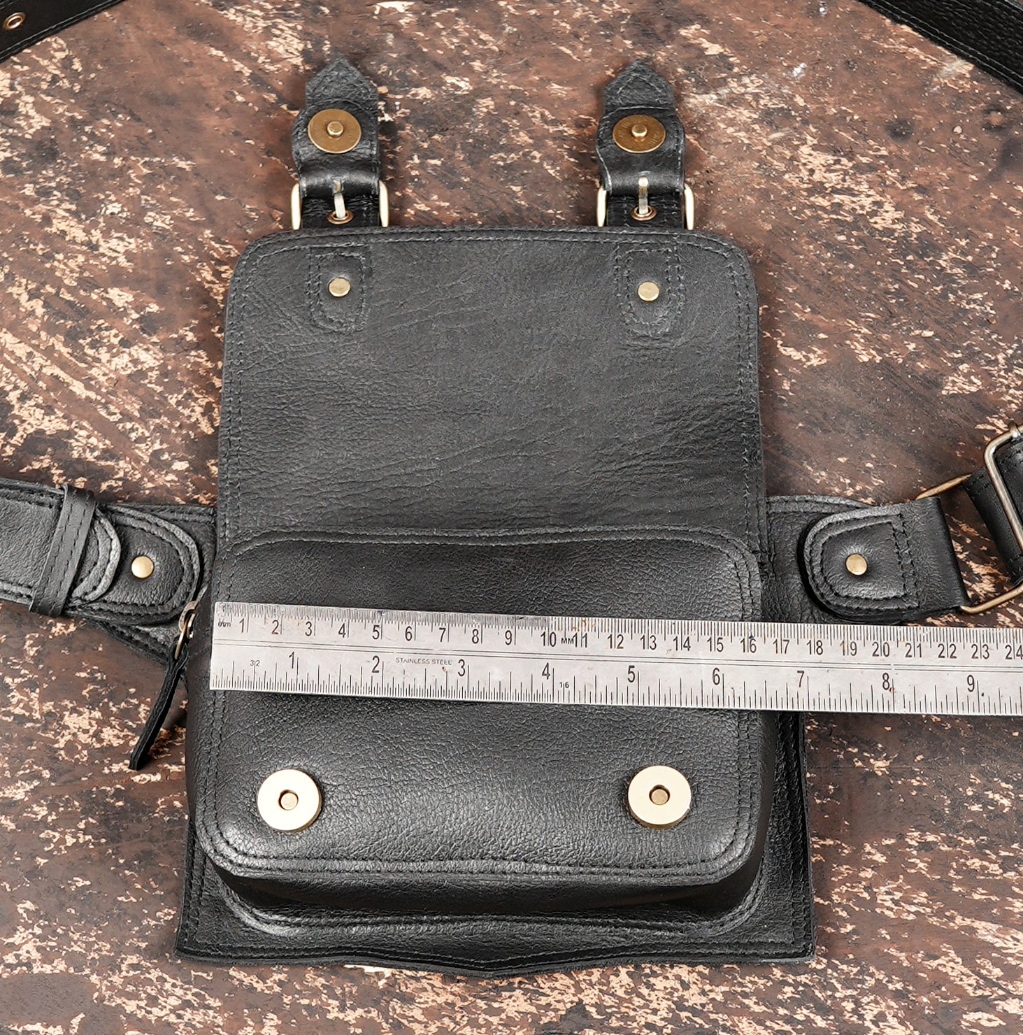 "Black leather belt pack with metal buckle fittings"