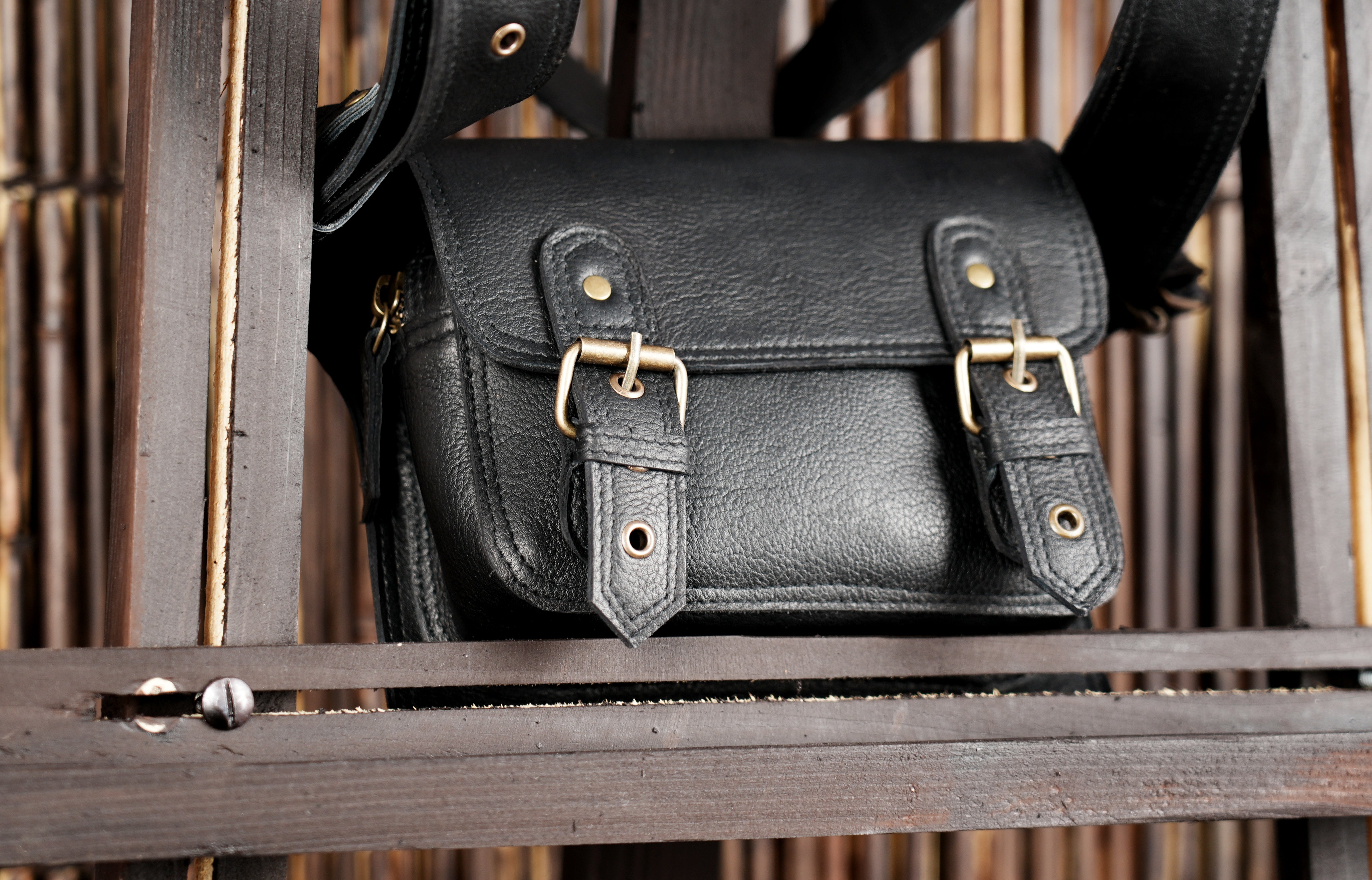 "Black leather utility pouch with reinforced stitching"