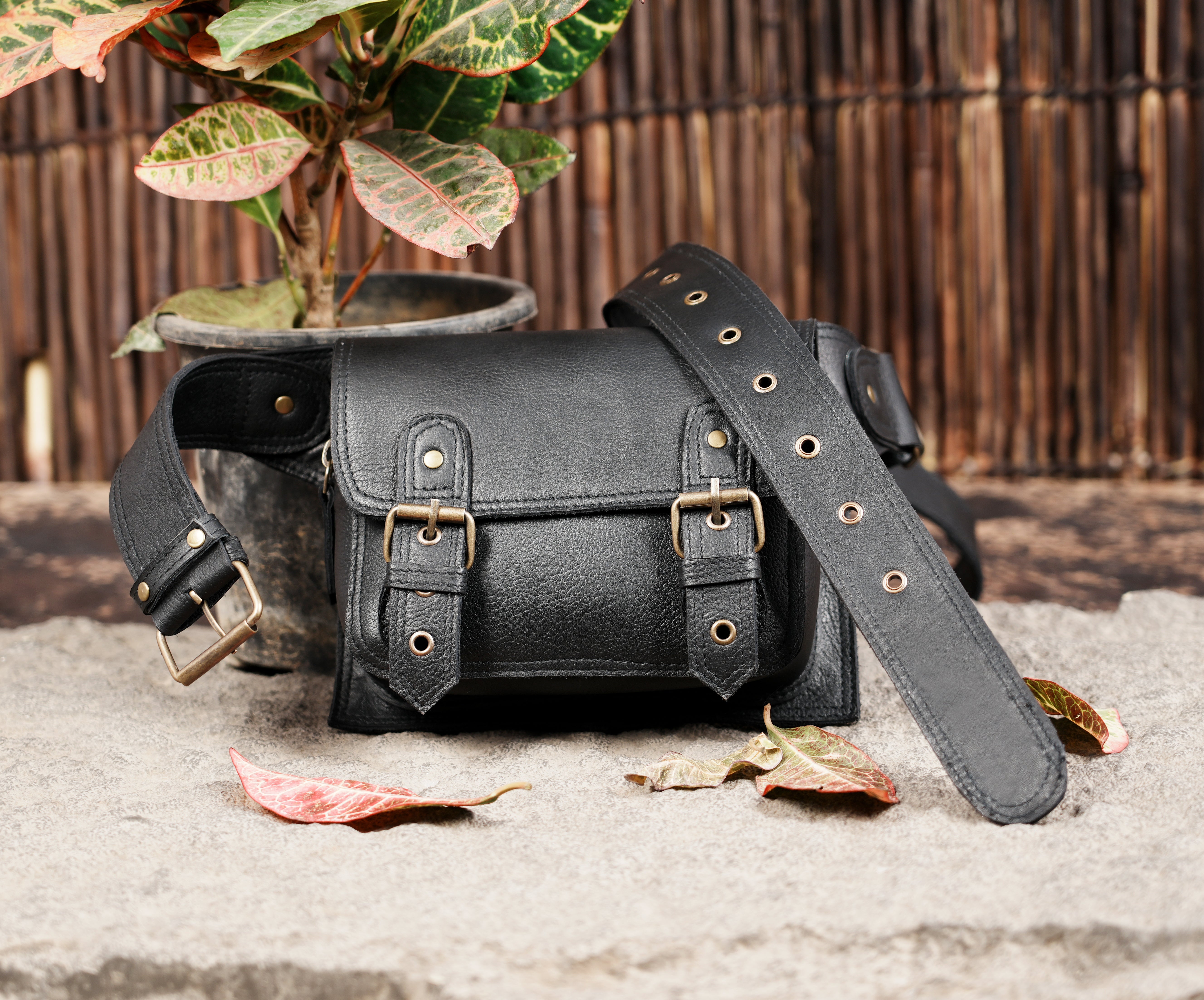 "Black handcrafted leather belt pouch with classic buckles"