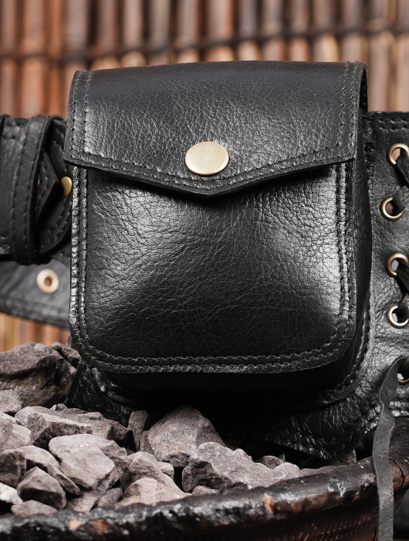 Rugged leather pocket belt with lace-up details and gemstone
