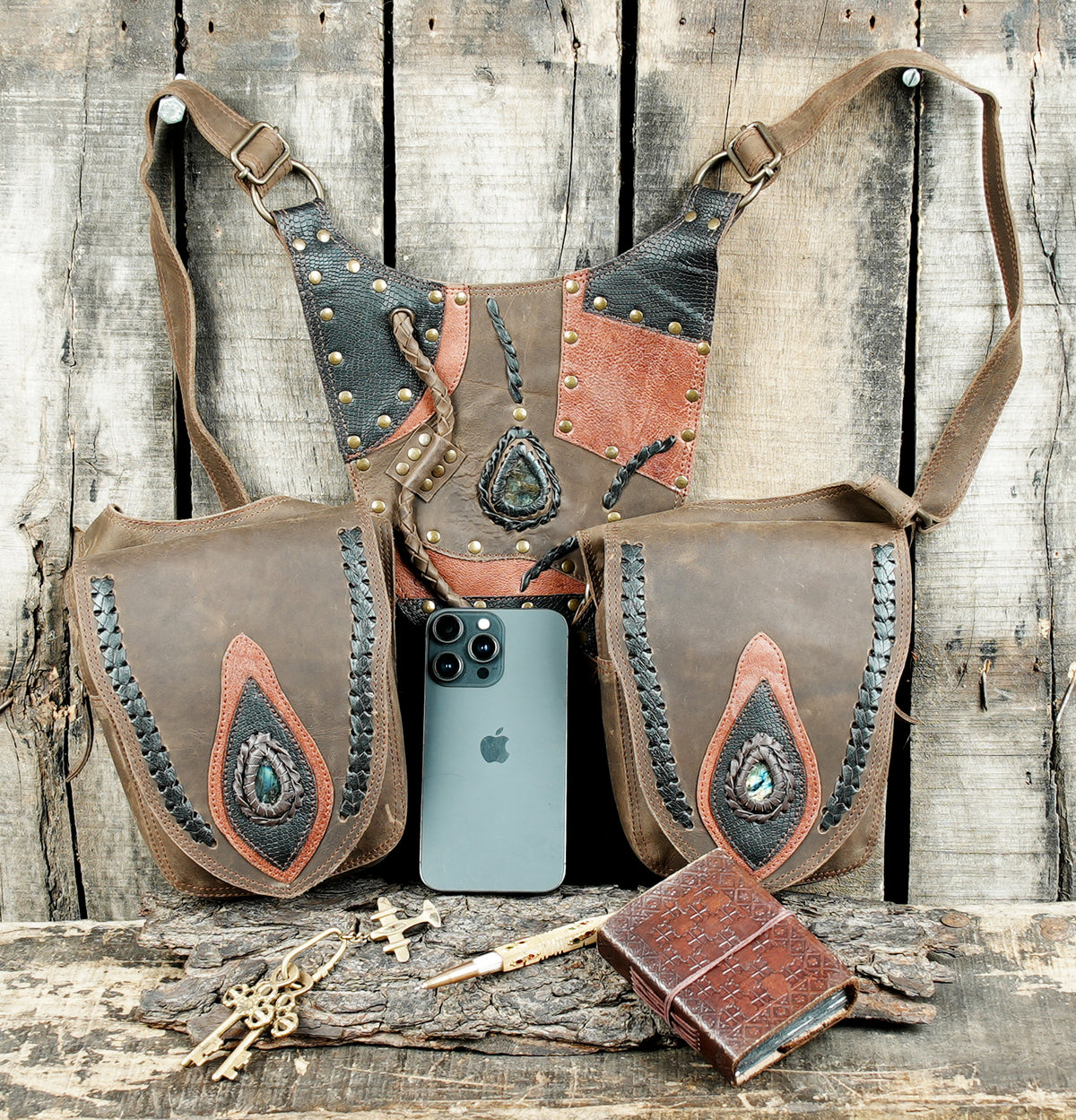 Brown leather utility waist bag with two large pockets and adjustable harness straps
 