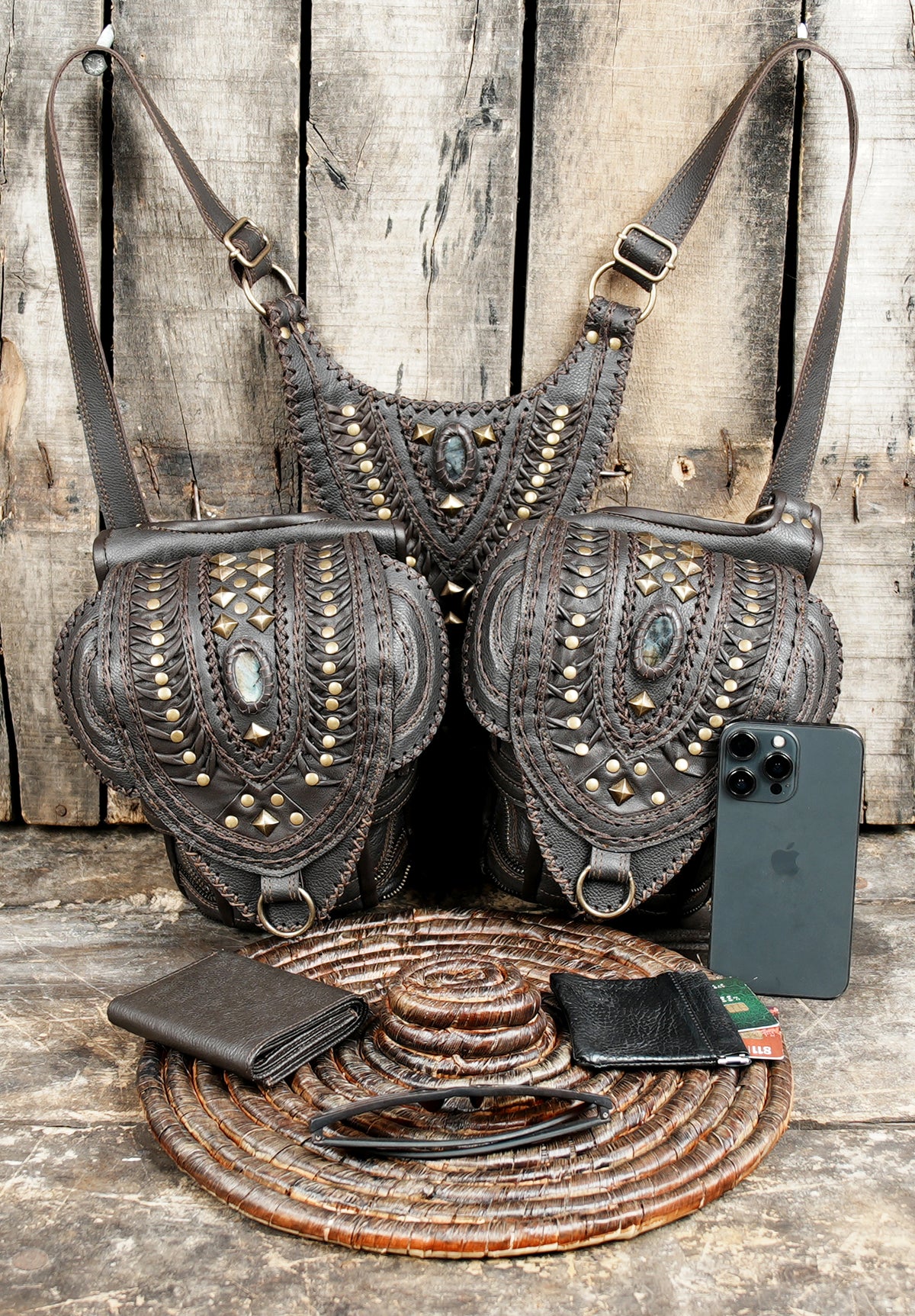Dark brown leather hip bags with studded covers and adjustable harness belts