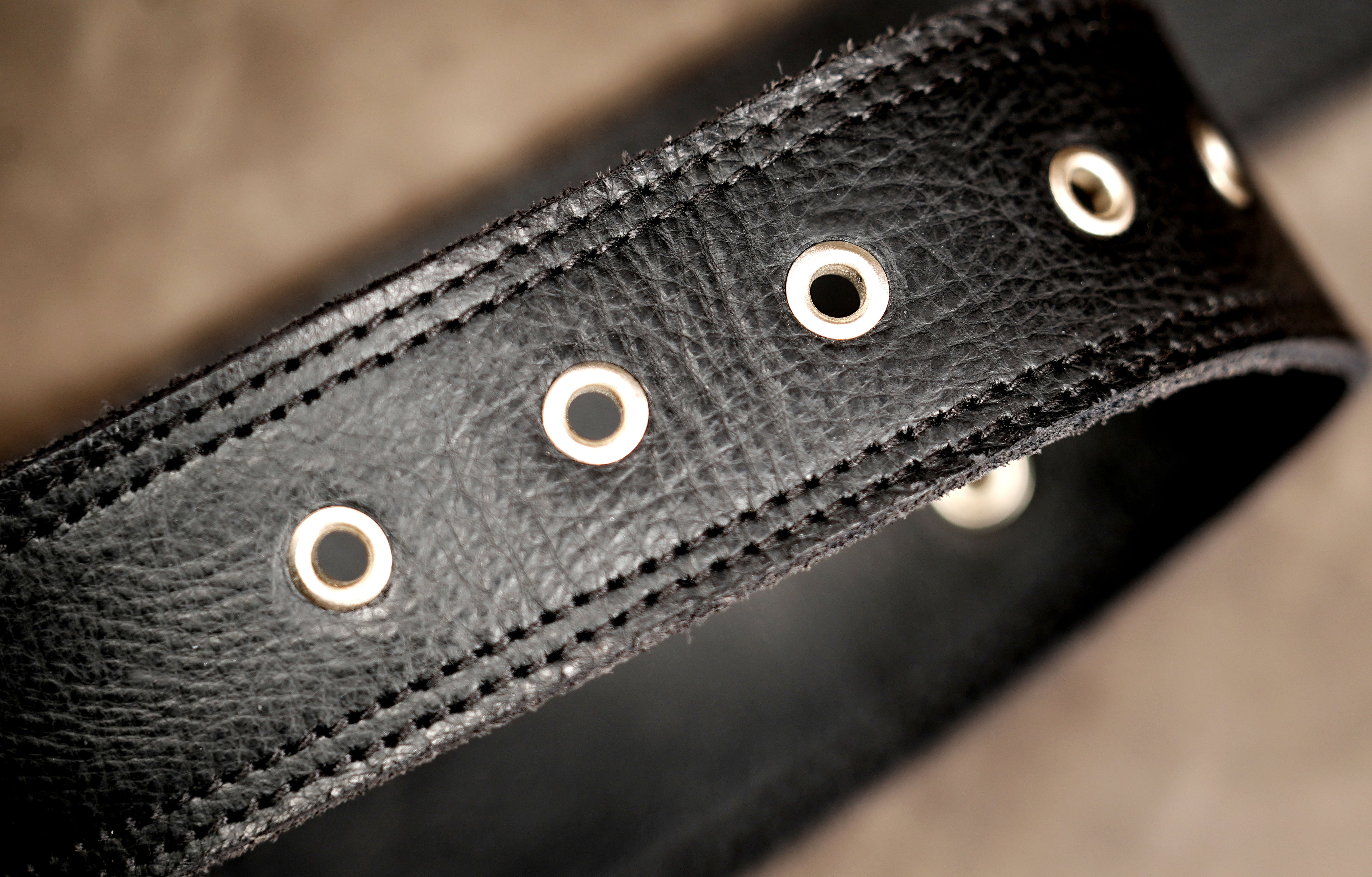 Distressed leather hip bag with silver buckles, close up
