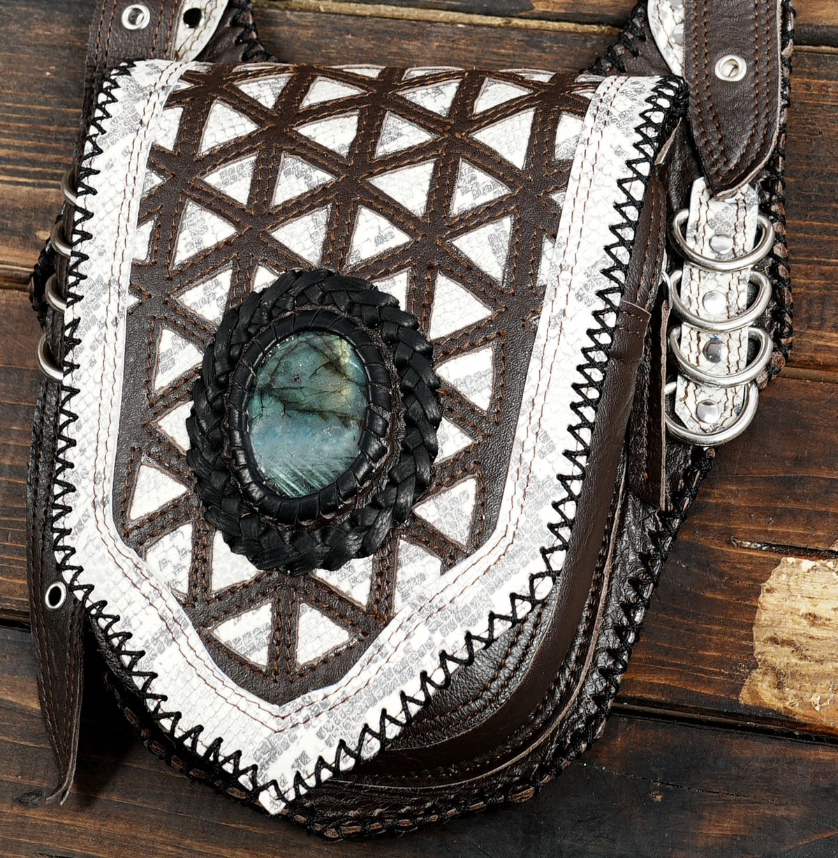 Double-pouch leather body bag with white geometric flap designs