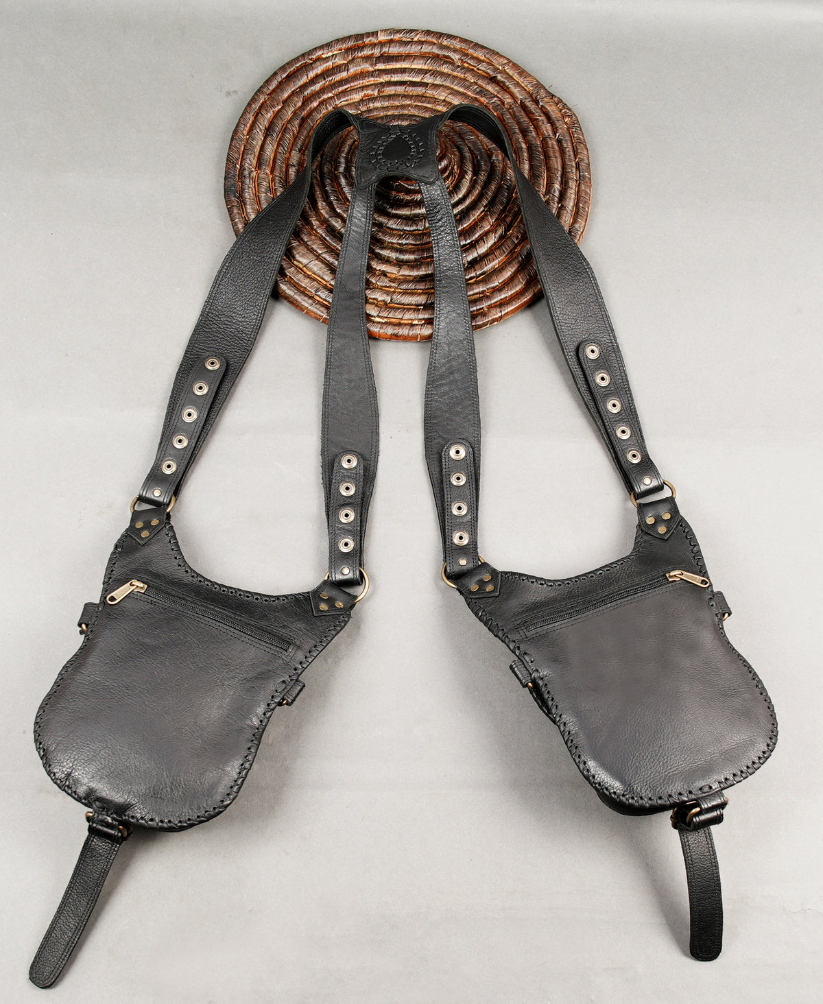 Artisan leather hip bags with braided edging and antique brass-tone hardware