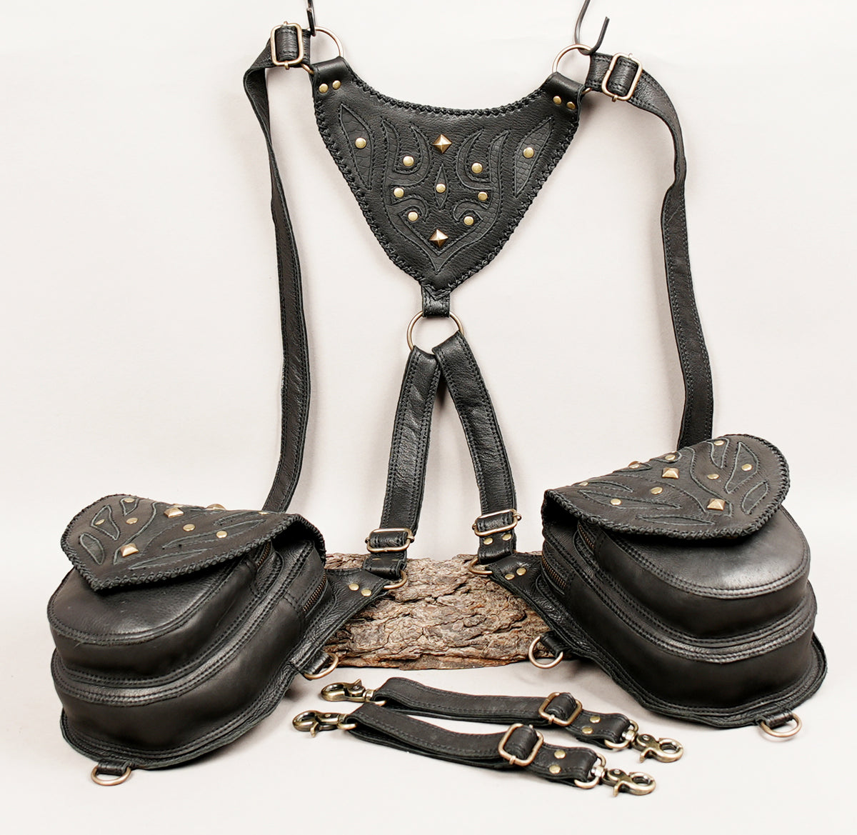Black leather harness bag set with a studded triangular chest harness, two matching side pouches, and detachable leg straps.