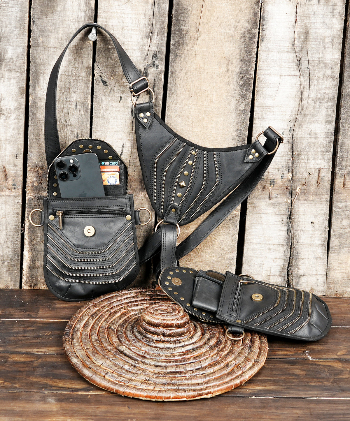 Black leather crossbody style harness with two hip pouches and metal ring attachment
