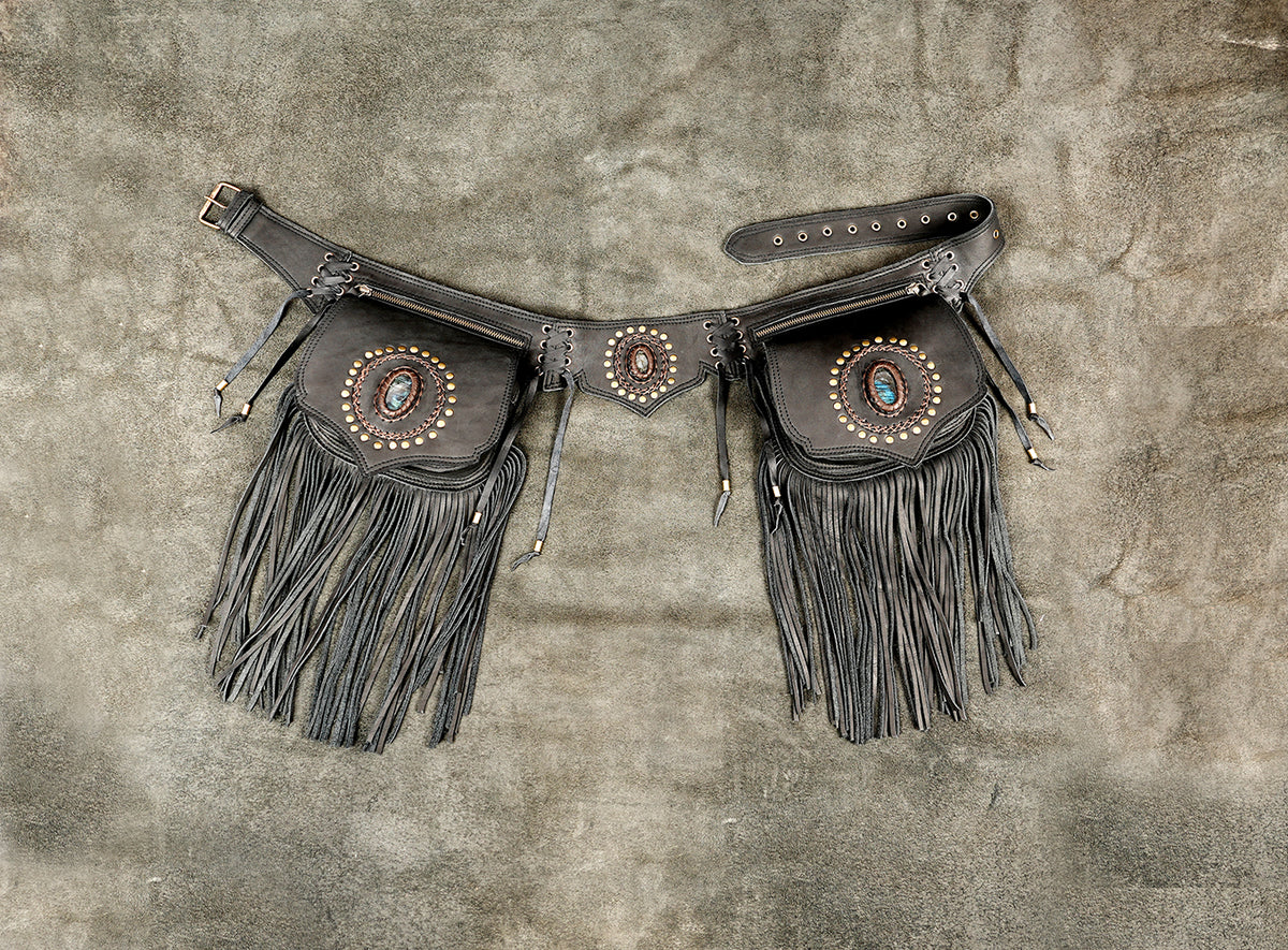 A pair of dark brown leather fringe pouches with decorative conchos and turquoise accents.