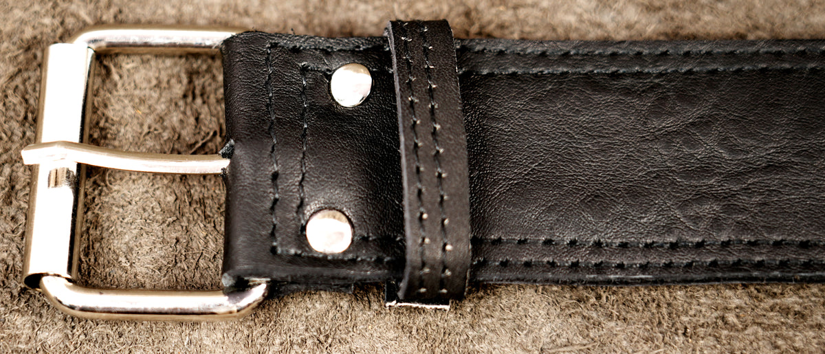 Elongated leather bag with decorative metal fastener