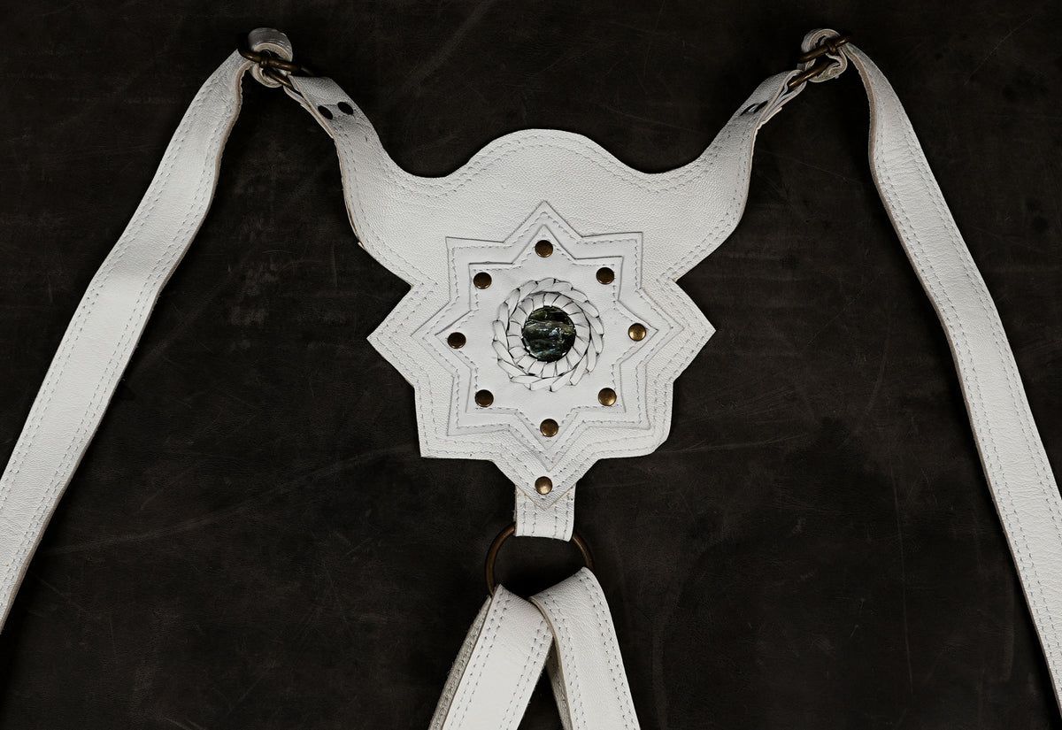 Fantasy character harness in ivory, dark background shot
