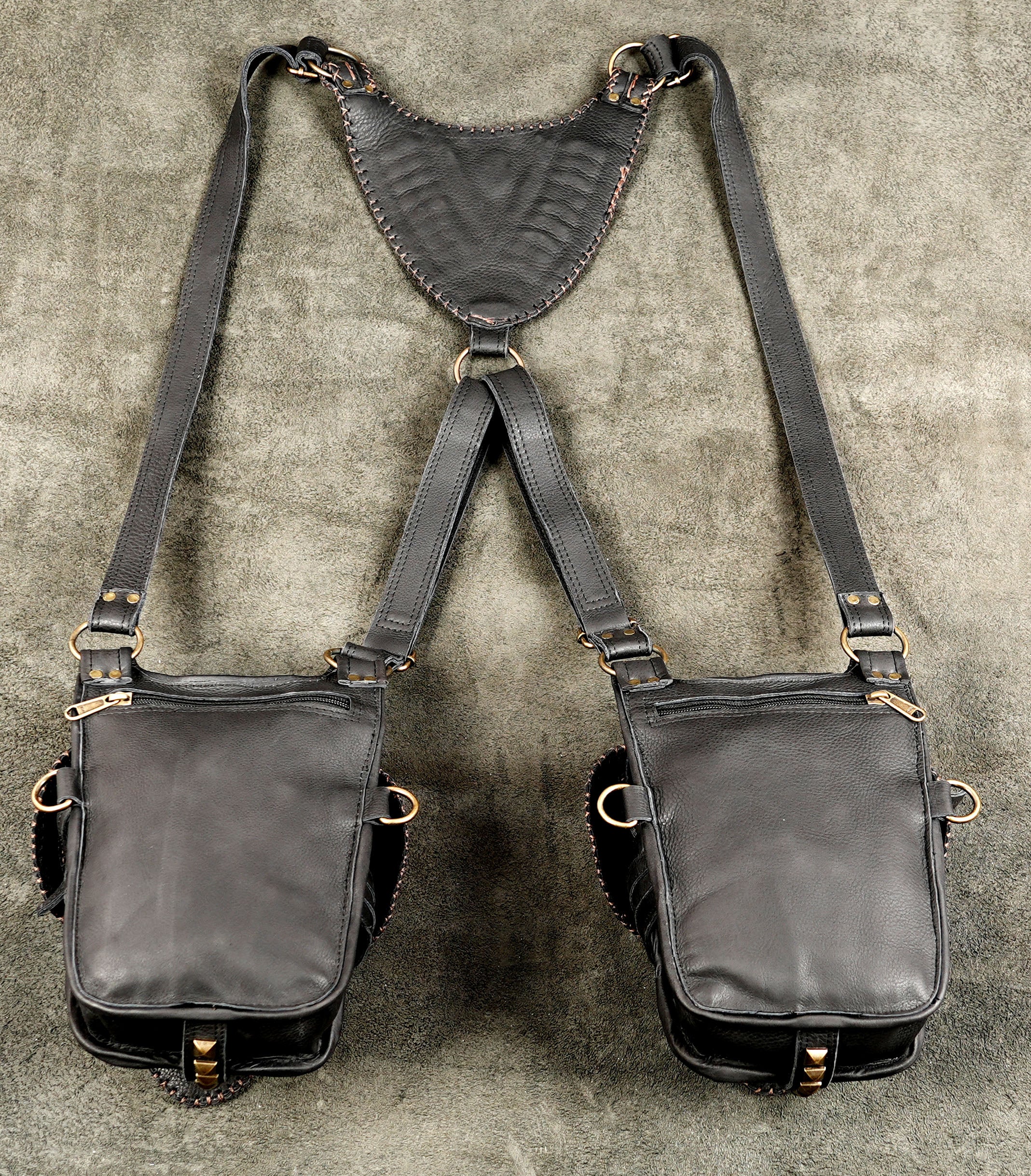 Festival-ready leather shoulder bag with secure pockets and brass fittings