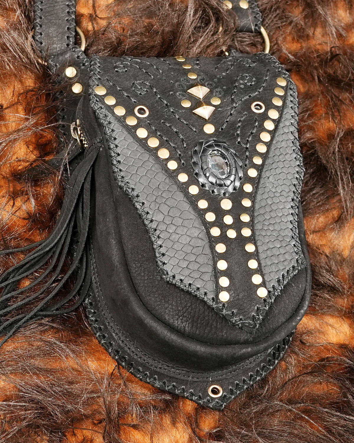 Handmade black leather leg bags with adjustable harness straps for rave wear and festival styling.