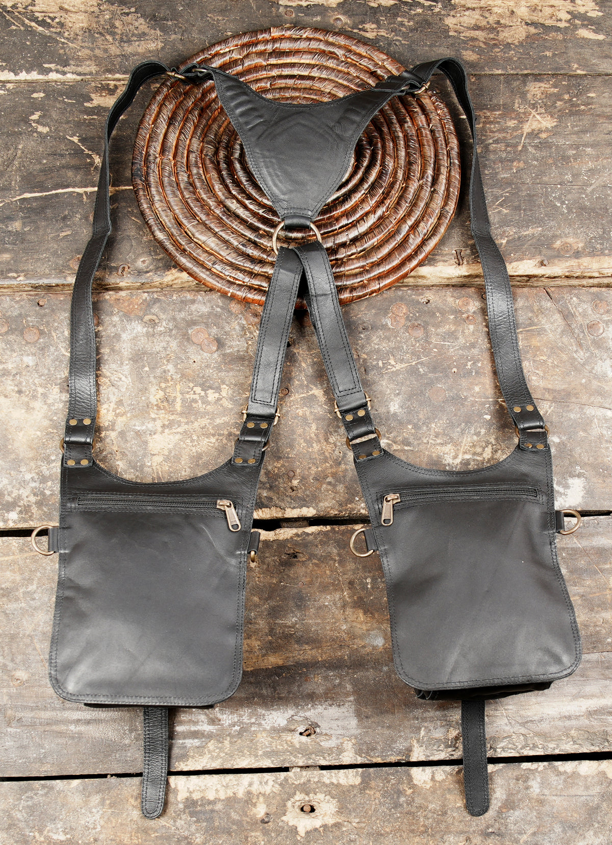 Black leather shoulder pouch harness with decorative stitching and practical storage