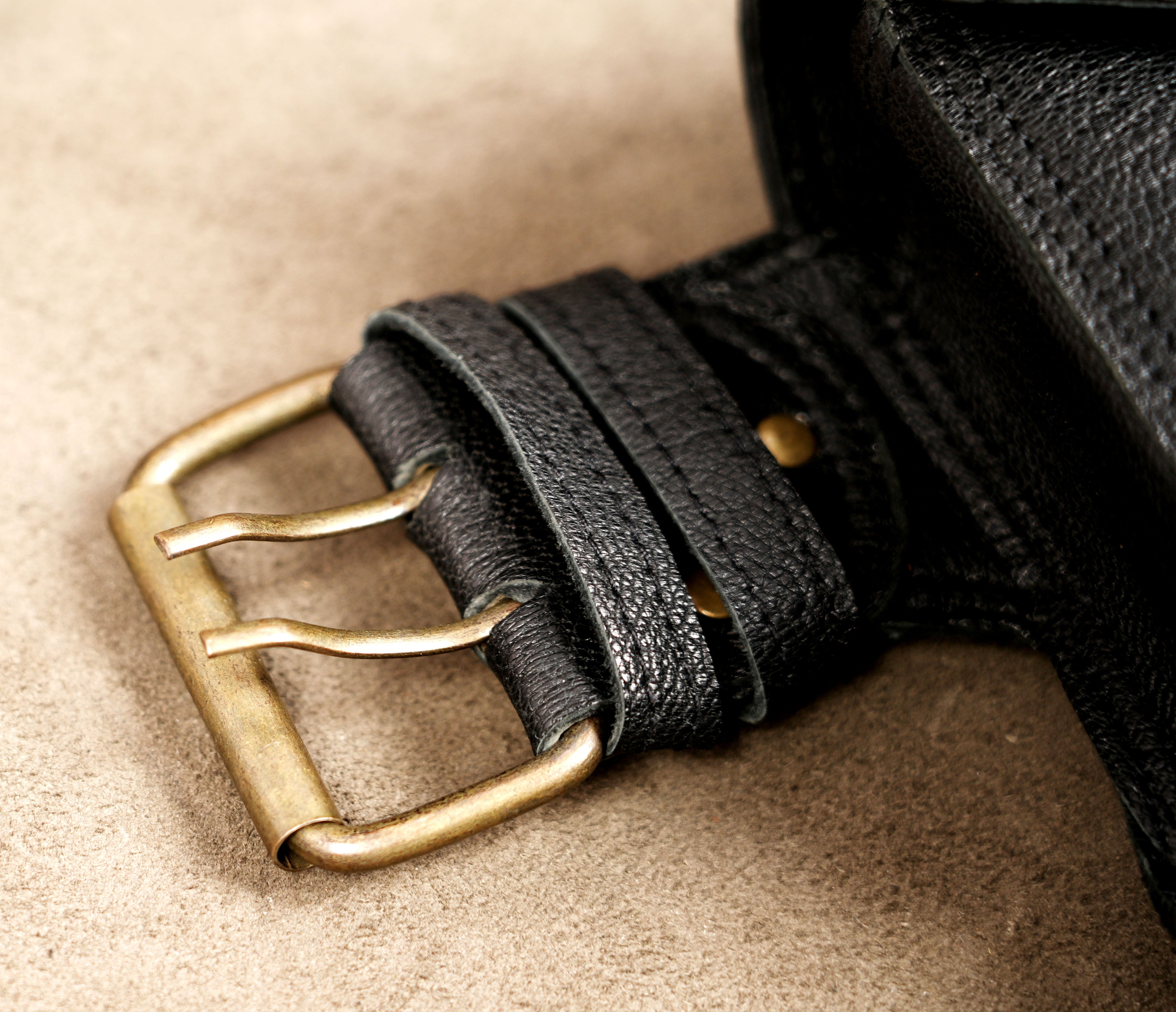 Genuine leather multi pouch belt styled on suede background