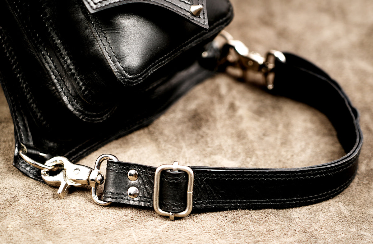 Genuine leather thigh holster styled on suede background