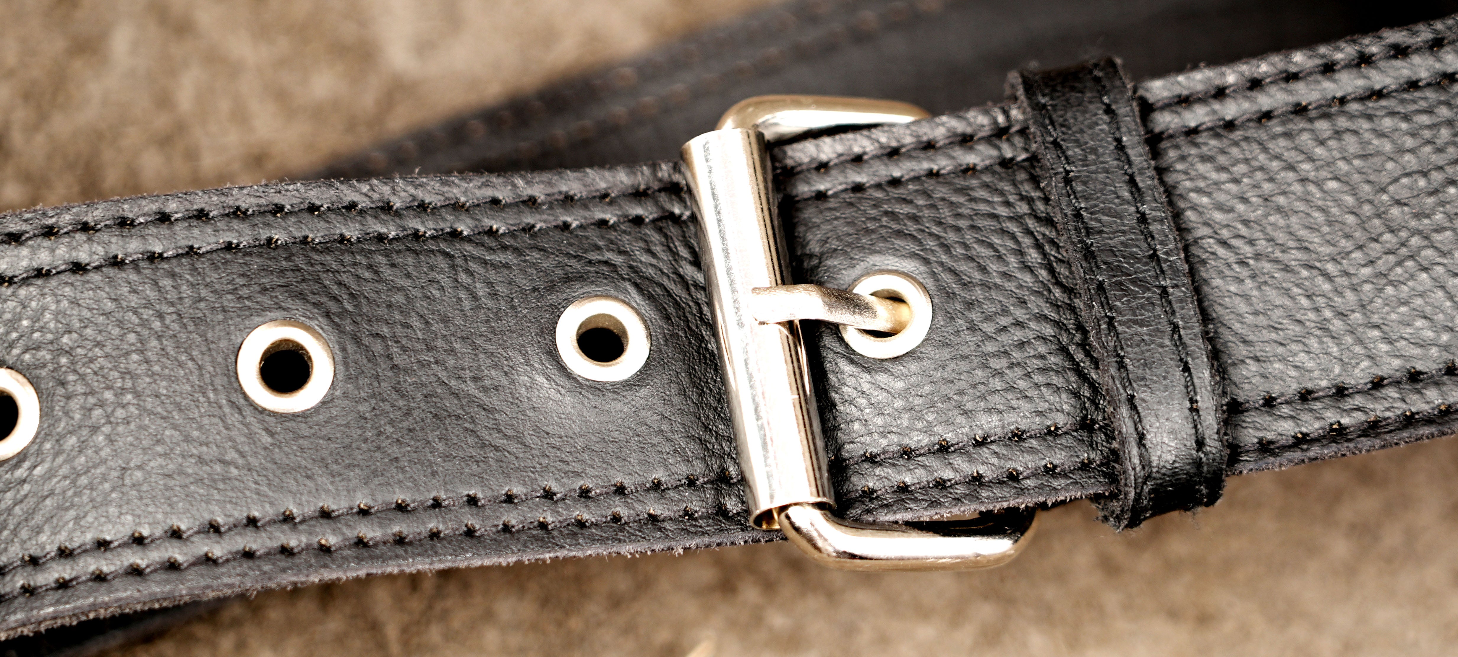 Genuine leather waist bag styled on suede background