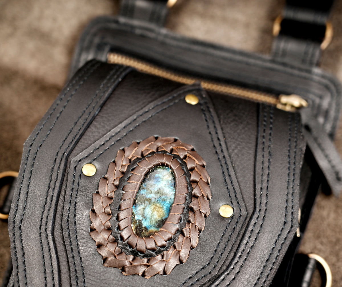 Ergonomic leather cross-body holster vest featuring dual phone pouches, brass hardware, and fringe trim.