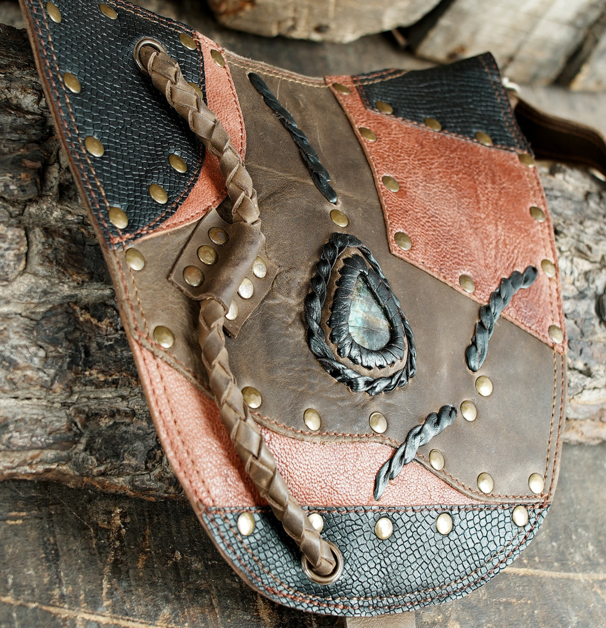 Leather shoulder harness with matching hip pouches and decorative gemstone panels
 