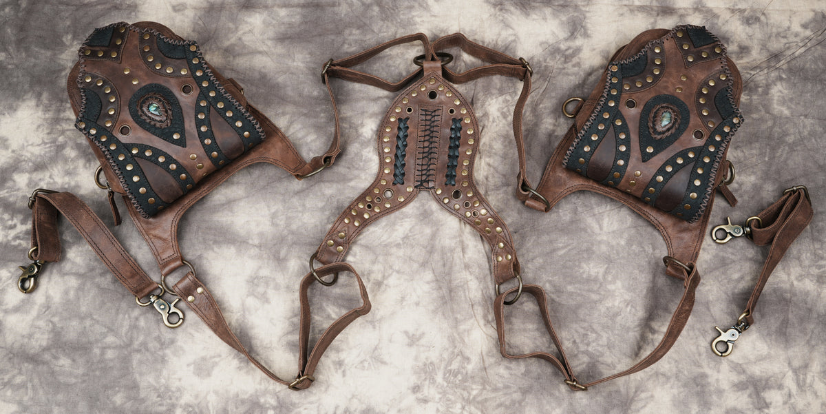 Handmade alternative fashion bag featuring symmetrical pouch designs and ornamental metal rings.