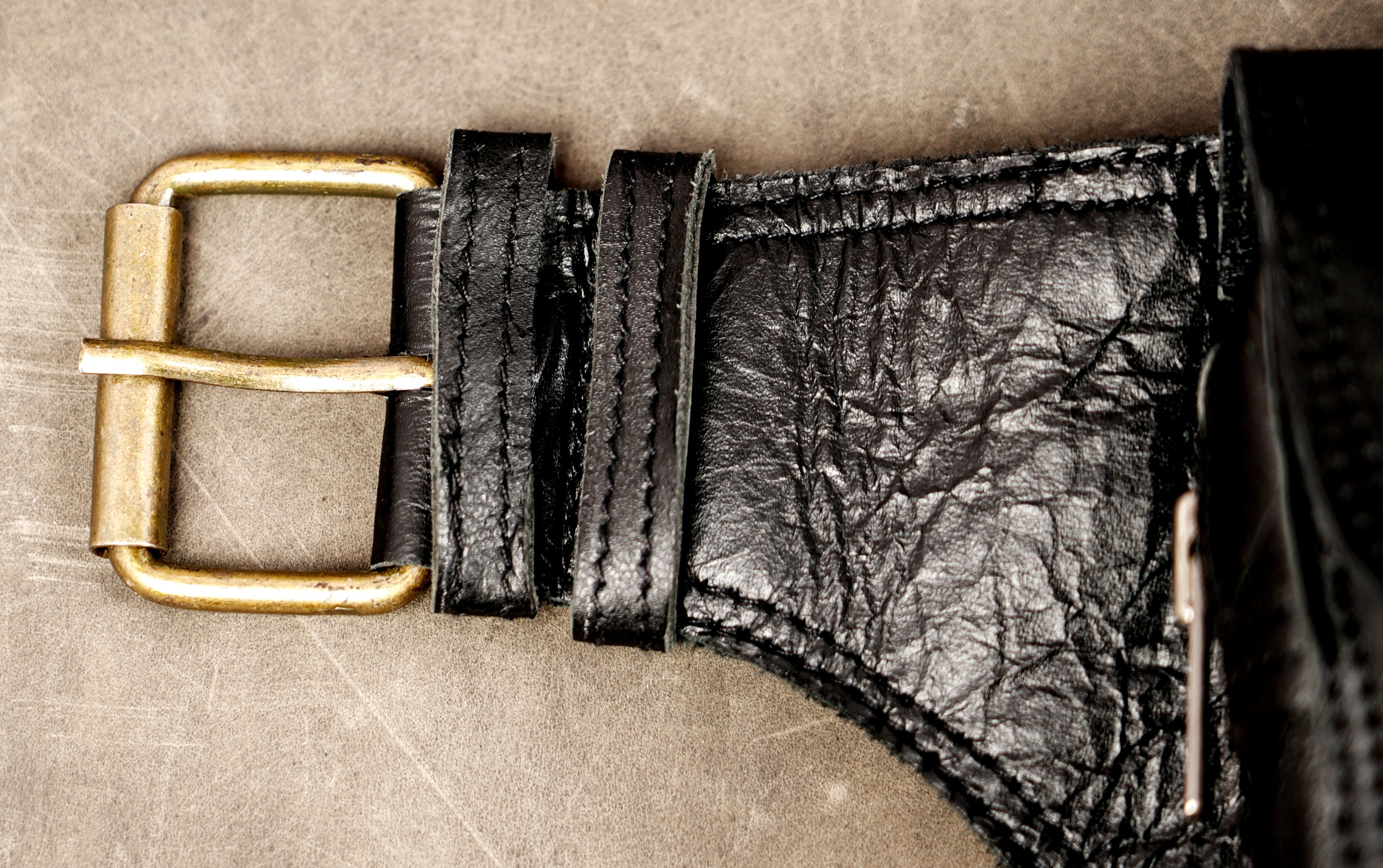 Gothic-style leather belt bag with multiple front pockets